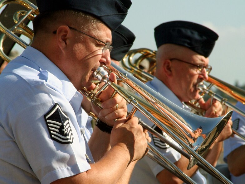 (From left) Master Sgts. Cecil Benjamin and Dave Parker,  trombone players with the Air Force's Band of the Golden West of Travis Air Force Base, Calif., play a tune during the opening ceremonies for Air Mobility Command's RODEO 2009 July 19 at McChord AFB, Wash.  More than 100 teams are participating in RODEO competition, including teams from seven foreign countries. RODEO is the U.S. Air Force's and AMC's premier air mobility competition. It's an international combat skills and flying operations competition designed to develop and improve techniques, procedures and interoperability with international partners to optimize mobility partnerships and enhance mobility operations. (U.S. Air Force Photo/Tech. Sgt. Scott T. Sturkol)