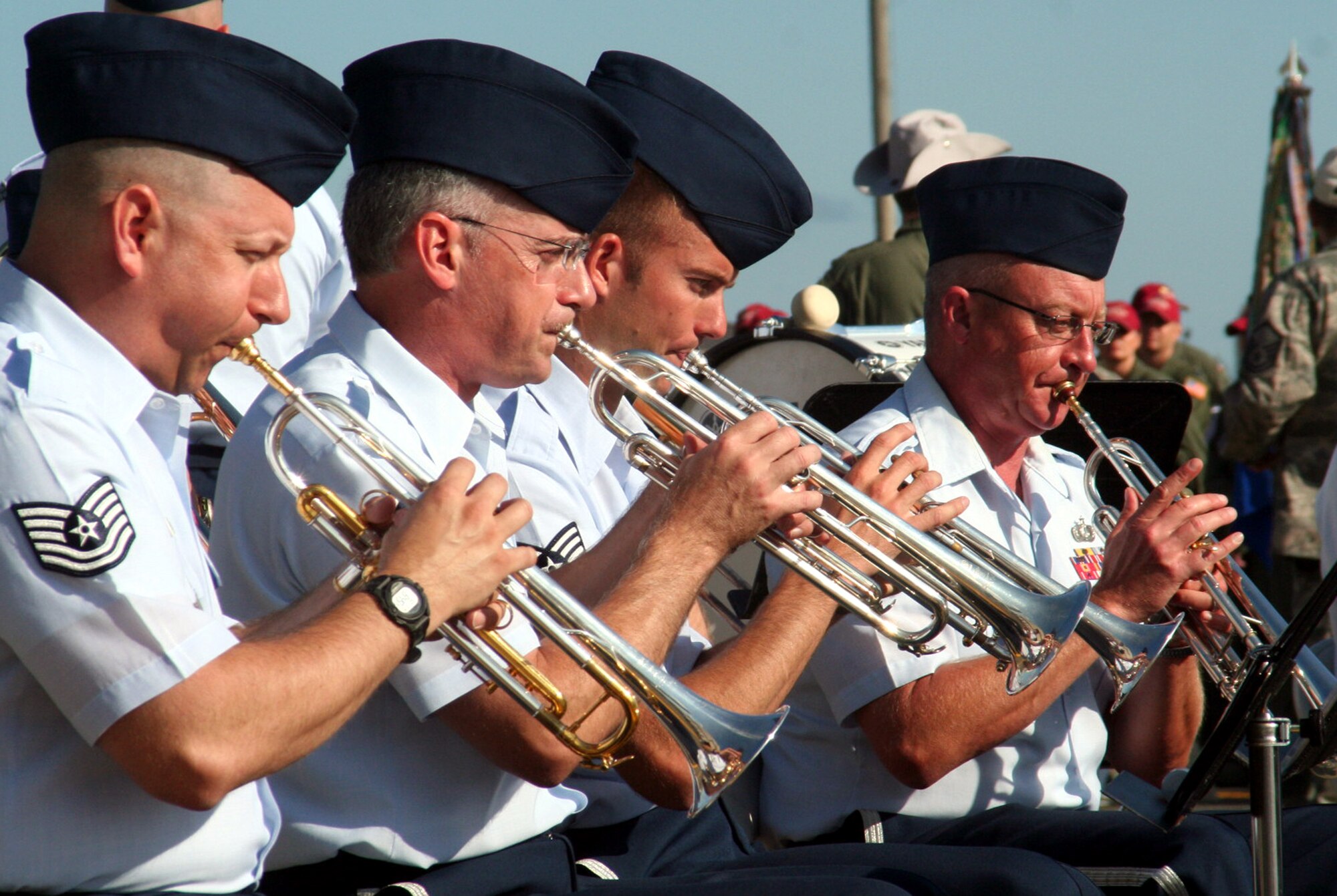 (From left) Tech. Sgt. Ed Schubert, Master Sgt. Brian Wood, Senior Airman Jamie Lantz, and Tech. Sgt. Jim Masters, all trumpet players with the Air Force's Band of the Golden West, play a tune during the opening ceremonies for Air Mobility Command's RODEO 2009 July 19 at McChord Air Force Base, Wash.  More than 100 teams are participating in RODEO competition, including teams from seven foreign countries. RODEO is the U.S. Air Force's and AMC's premier air mobility competition. It's an international combat skills and flying operations competition designed to develop and improve techniques, procedures and interoperability with international partners to optimize mobility partnerships and enhance mobility operations. (U.S. Air Force Photo/Tech. Sgt. Scott T. Sturkol)