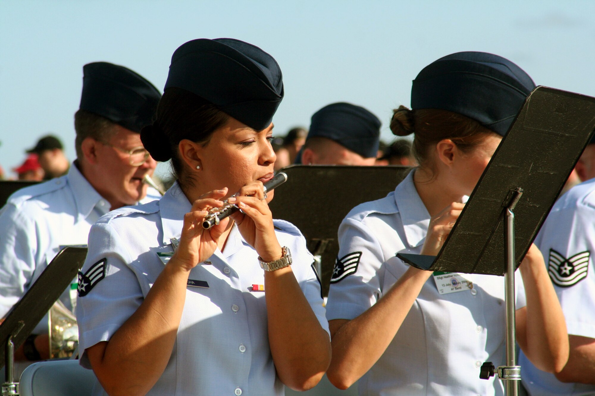 Senior Airman Melissa Rocha, flute player with the Air Force's Band of the Golden West of Travis Air Force Base, Calif., plays a tune during the opening ceremonies for Air Mobility Command's RODEO 2009 July 19 at McChord Air Force Base, Wash.  More than 100 teams are participating in RODEO competition, including teams from seven foreign countries. RODEO is the U.S. Air Force's and AMC's premier air mobility competition. It's an international combat skills and flying operations competition designed to develop and improve techniques, procedures and interoperability with international partners to optimize mobility partnerships and enhance mobility operations. (U.S. Air Force Photo/Tech. Sgt. Scott T. Sturkol)