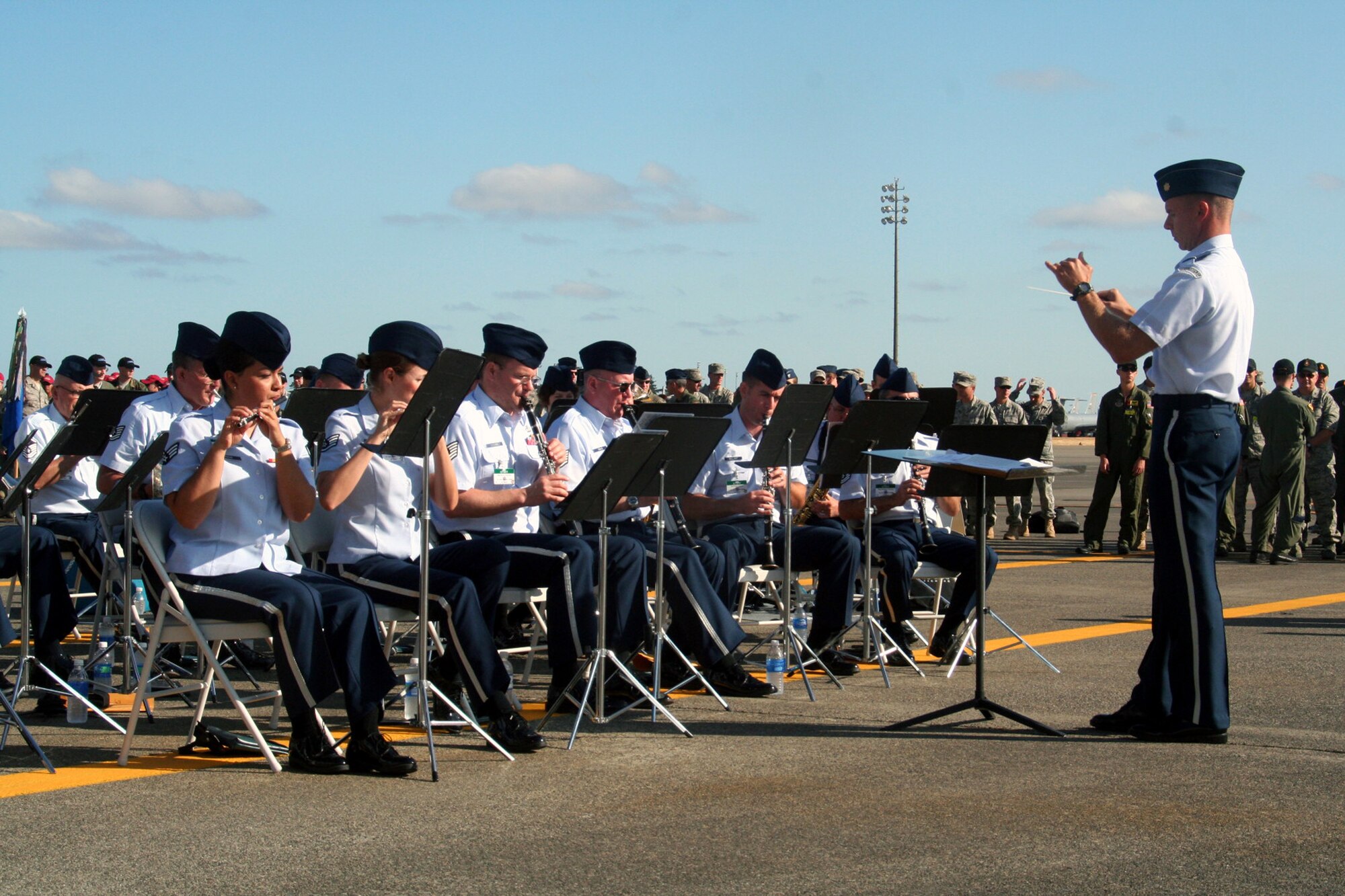 Maj. Keith Bland (right), conductor/commander of the Air Force's Band of the Golden West of Travis Air Force Base, Calif., leads direction of the band as they play during the opening ceremonies for Air Mobility Command's RODEO 2009 July 19 at McChord Air Force Base, Wash.  More than 100 teams are participating in RODEO competition, including teams from seven foreign countries. RODEO is the U.S. Air Force's and AMC's premier air mobility competition. It's an international combat skills and flying operations competition designed to develop and improve techniques, procedures and interoperability with international partners to optimize mobility partnerships and enhance mobility operations. (U.S. Air Force Photo/Tech. Sgt. Scott T. Sturkol)