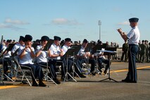 Maj. Keith Bland (right), conductor/commander of the Air Force's Band of the Golden West of Travis Air Force Base, Calif., leads direction of the band as they play during the opening ceremonies for Air Mobility Command's RODEO 2009 July 19 at McChord Air Force Base, Wash.  More than 100 teams are participating in RODEO competition, including teams from seven foreign countries. RODEO is the U.S. Air Force's and AMC's premier air mobility competition. It's an international combat skills and flying operations competition designed to develop and improve techniques, procedures and interoperability with international partners to optimize mobility partnerships and enhance mobility operations. (U.S. Air Force Photo/Tech. Sgt. Scott T. Sturkol)