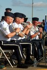 (From left) Tech. Sgt. Ed Schubert, Master Sgt. Brian Wood, Senior Airman Jamie Lantz, and Tech. Sgt. Jim Masters, all trumpet players with the Air Force's Band of the Golden West, play a tune during the opening ceremonies for Air Mobility Command's RODEO 2009 July 19 at McChord Air Force Base, Wash.  More than 100 teams are participating in RODEO competition, including teams from seven foreign countries. RODEO is the U.S. Air Force's and AMC's premier air mobility competition. It's an international combat skills and flying operations competition designed to develop and improve techniques, procedures and interoperability with international partners to optimize mobility partnerships and enhance mobility operations. (U.S. Air Force Photo/Tech. Sgt. Scott T. Sturkol)