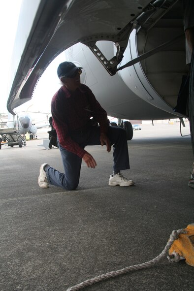 Artist Jack Lutzlow, from San Francisco, Calif., and a participating artist in the Air Force Art Program, looks in the wheel compartment of a C-17 Globemaster III during a visit Air Mobility RODEO 2009 July 20 at McChord Air Force Base, Wash. Mr. Renaud is among a group of four artists visiting RODEO to document it for future art pieces in the Air Force Art Program. (U.S. Air Force Photo/Tech. Sgt. Scott T. Sturkol)