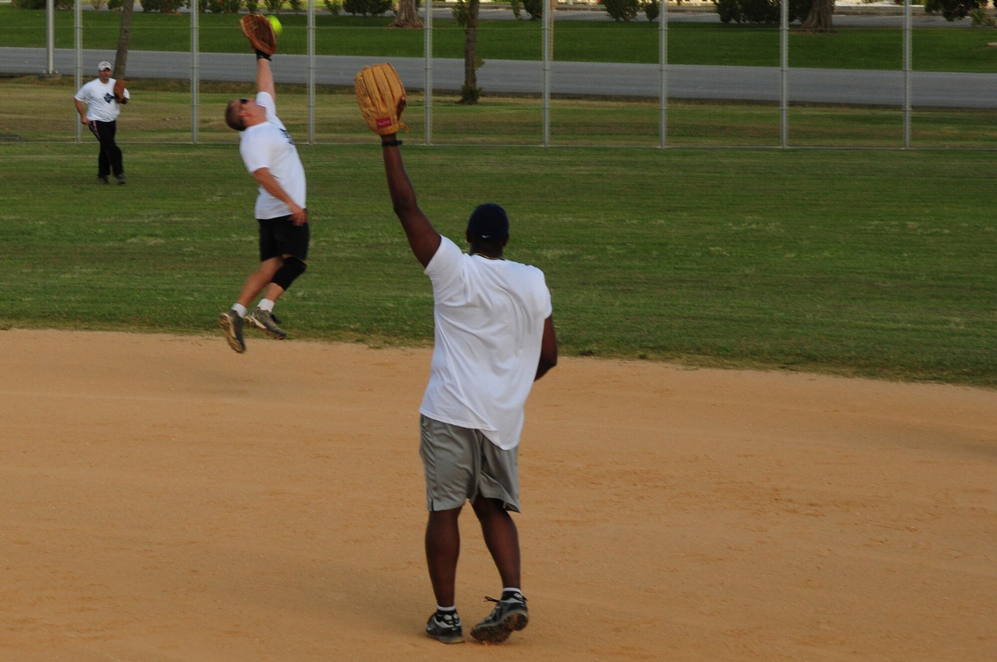Airman from Dorm 630 misses a catch on a hit by a Dorm 700 resident at the Dorm Softball Tournament at Kadena Air Base July 18. The First Sergeants Assocation, which sponsored the event, plans to hold the tournament annually.