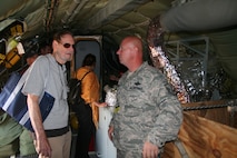 Artist Phillip Renaud, from Chicago, Ill., and a participating artist in the Air Force Art Program, talks with Master Sgt. Stacy Julian, an aeromedical evacuation competition umpire from the 446th Aeromedical Evacuation Squadron, during Air Mobility RODEO 2009 July 20 at McChord Air Force Base, Wash. Mr. Renaud is among a group of four artists visiting RODEO to document it for future art pieces in the Air Force Art Program. (U.S. Air Force Photo/Tech. Sgt. Scott T. Sturkol)