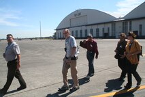 Mr. Jeff Michalke, Air Mobility Command's coordinator for the Air Force Art Program at Scott Air Force Base, Ill., leads a group of four artists who are observing competition for Air Mobility RODEO 2009 July 20 at McChord AFB, Wash. More than 100 teams are participating in RODEO competition, including teams from seven foreign countries. RODEO is the U.S. Air Force's and AMC's premier air mobility competition. It's an international combat skills and flying operations competition designed to develop and improve techniques, procedures and interoperability with international partners to optimize mobility partnerships and enhance mobility operations. (U.S. Air Force Photo/Tech. Sgt. Scott T. Sturkol)