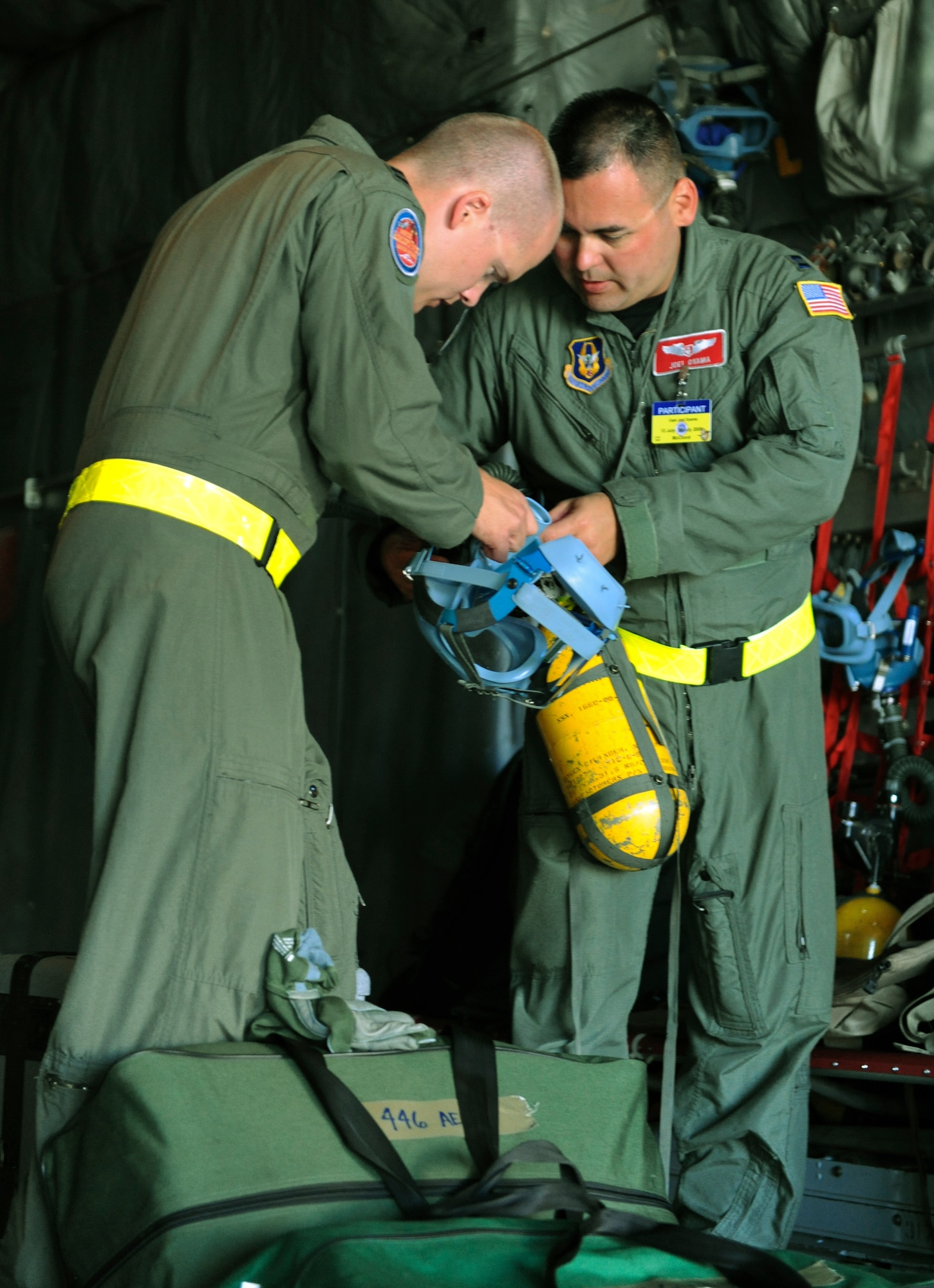Capt. Joe Foss assists Capt. Joel Oyama with his MA-1 walk around bottle for the Aeromedical Evacuation Competition during Air Mobility RODEO 2009, at McChord Air Force Base, Wash., July 20. RODEO is an international combat skills and flying operations competition designed to develop and improve techniques and procedures with our international partners to enhance mobility operations. (U.S.Air Force photo by Tech Sgt. Michelle Larche/Released)