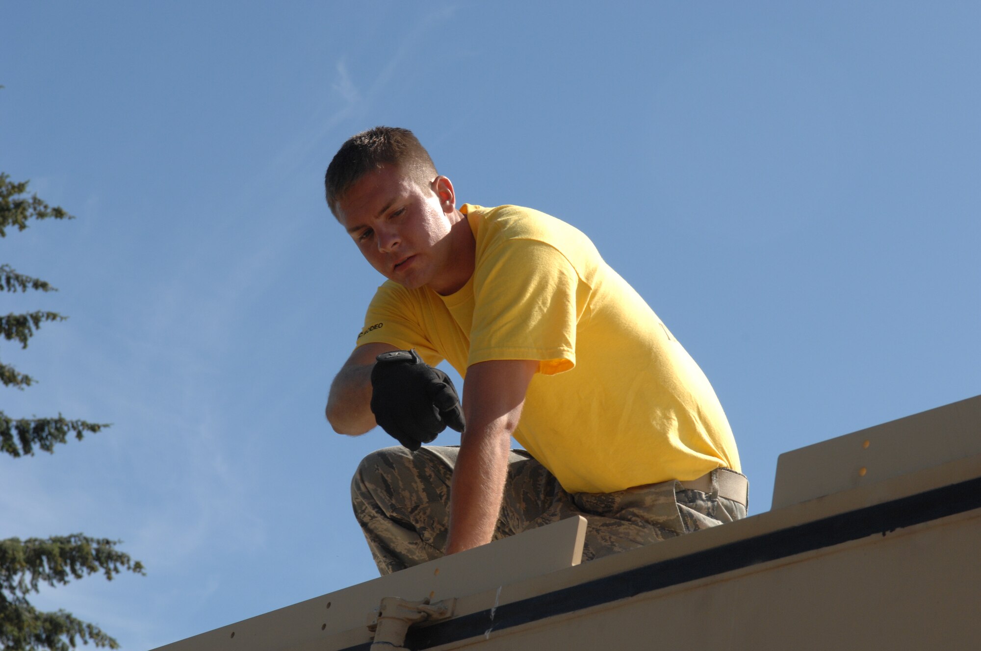 An Airman from 615th Contingency Response Wing of Travis Air Force Base, Calif., assembles the Hard-sided Expandable Light Air Mobile Shelter, or HELAMS, during Air Mobility RODEO 2009 competition July 20, 2009, at McChord Air Force Base, Wash.  Use of the shelter is a first for RODEO competition.  (U.S. Air Force Photo/Senior Airman Eric Ysasi)