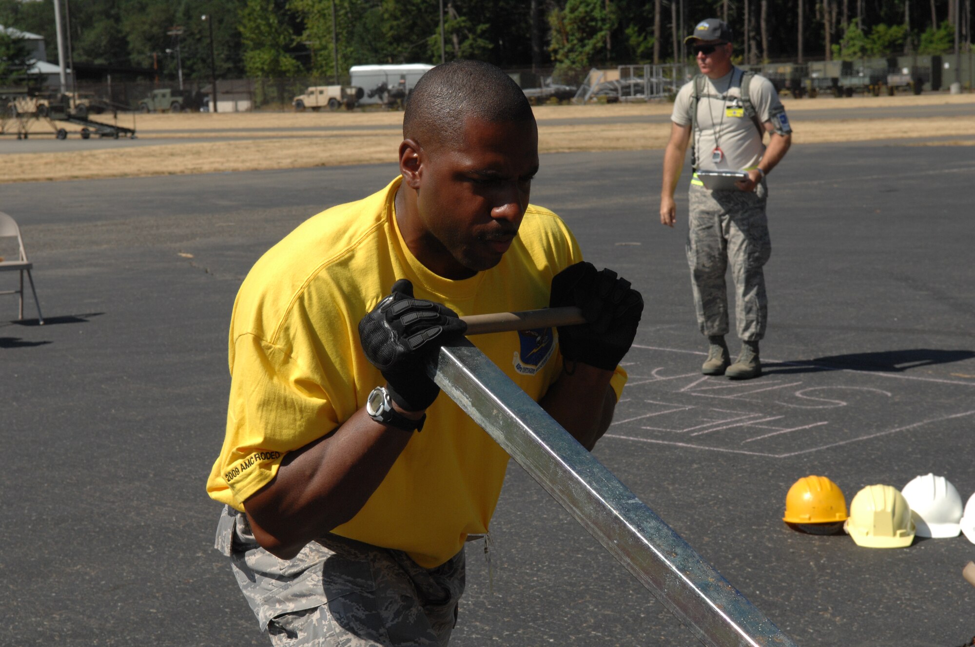 An Airman from 615th Contingency Response Wing of Travis Air Force Base, Calif., assembles the Hard-sided Expandable Light Air Mobile Shelter, or HELAMS, during Air Mobility RODEO 2009 competition July 20, 2009, at McChord Air Force Base, Wash.  Use of the shelter is a first for RODEO competition.  (U.S. Air Force Photo/Senior Airman Eric Ysasi)