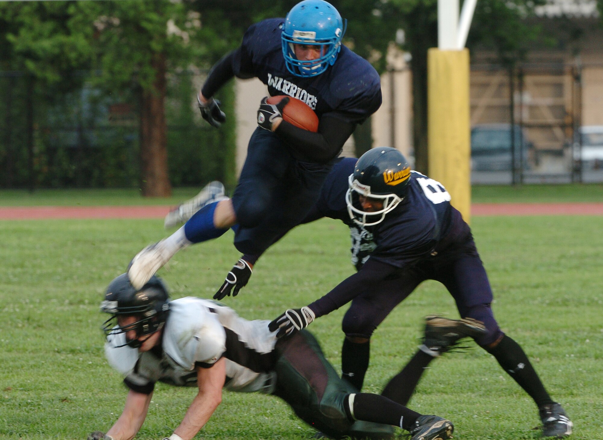 YOKOTA AIR BASE, Japan -- Yokota Warriors' running back Kevin Fortin hurdles a Misawa Jets' defender during Yokota's 44-12 defeat of the Jets July 18 in the first round of the U.S. Forces Japan-American Football League playoffs at Bonk Field. The Warriors scored three defensive touchdowns in the first half to put the game out of reach early. Yokota travels to Yokosuka Aug. 1 to take on the Seahawks at 7 p.m. (U.S. Air Force photo/Master Sgt. Matt Summers)
