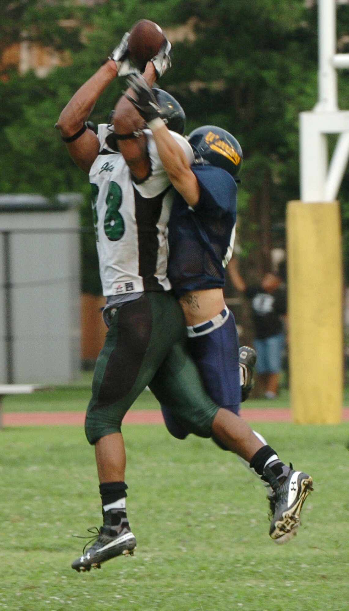YOKOTA AIR BASE, Japan -- Yokota Warriors' cornerback Stephen Pasion drapes himself over a Misawa Jets' receiver during the second quarter of Yokota's 44-12 defeat of the Jets July 18 in the first round of the U.S. Forces Japan-American Football League playoffs at Bonk Field. The Warriors scored three defensive touchdowns in the first half to put the game out of reach early. Yokota travels to Yokosuka Aug. 1 to take on the Seahawks at 7 p.m. (U.S. Air Force photo/Master Sgt. Matt Summers)