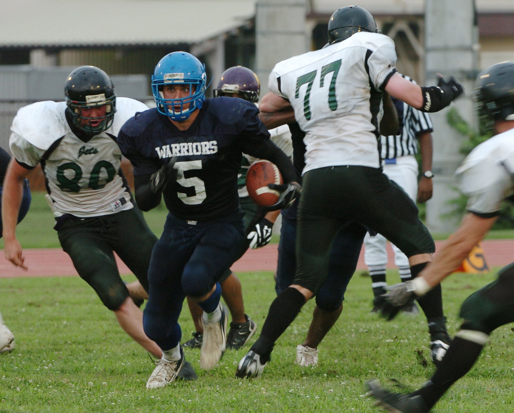 YOKOTA AIR BASE, Japan -- Yokota Warriors' running back Kevin Fortin looks for running room during Yokota's 44-12 defeat of the Misawa Jets July 18 in the first round of the U.S. Forces Japan-American Football League playoffs at Bonk Field. The Warriors scored three defensive touchdowns in the first half to put the game out of reach early. Yokota travels to Yokosuka Aug. 1 to take on the Seahawks at 7 p.m. (U.S. Air Force photo/Master Sgt. Matt Summers)