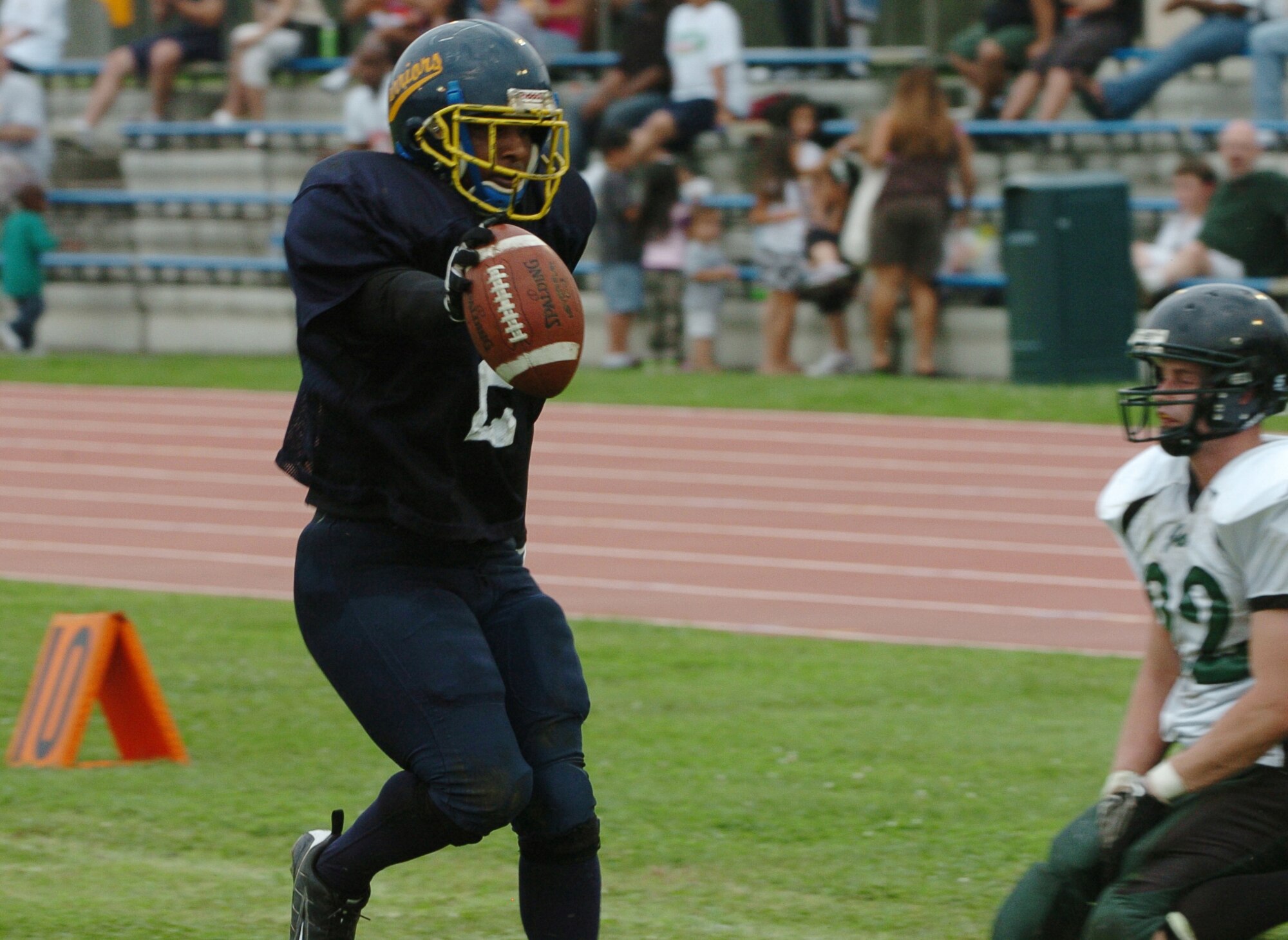 YOKOTA AIR BASE, Japan -- Yokota Warriors' running back Dell Washington pushes the ball into the end zone after juking a Misawa Jets' defender during the second quarter of Yokota's 44-12 defeat of the Jets July 18 in the first round of the U.S. Forces Japan-American Football League playoffs at Bonk Field. The Warriors scored three defensive touchdowns in the first half to put the game out of reach early. Yokota travels to Yokosuka Aug. 1 to take on the Seahawks at 7 p.m. (U.S. Air Force photo/Master Sgt. Matt Summers)