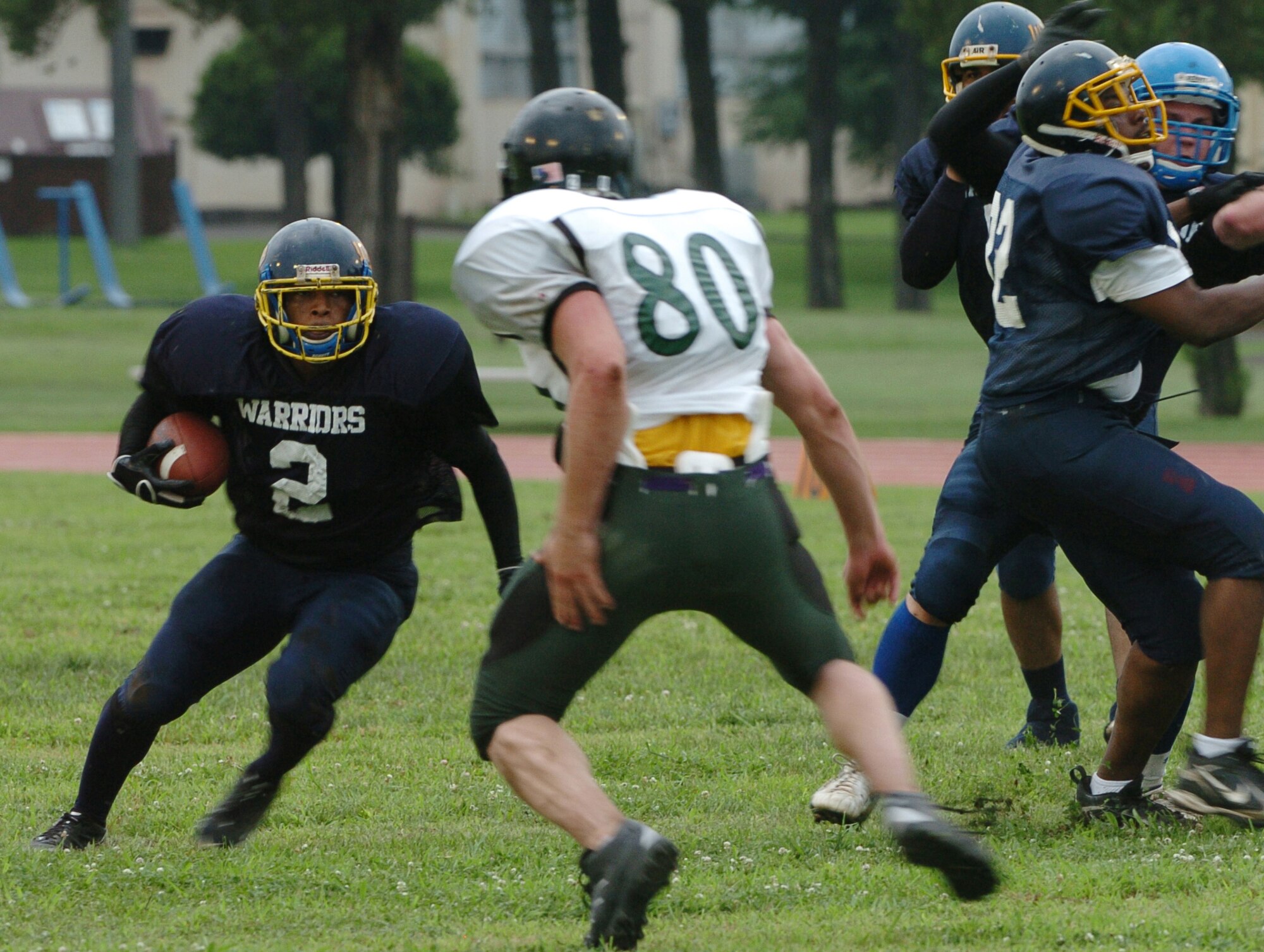 YOKOTA AIR BASE, Japan -- Yokota Warriors' running back Dell Washington looks for running room during the first quarter of Yokota's 44-12 defeat of the Jets July 18 in the first round of the U.S. Forces Japan-American Football League playoffs at Bonk Field. The Warriors scored three defensive touchdowns in the first half to put the game out of reach early. Yokota travels to Yokosuka Aug. 1 to take on the Seahawks at 7 p.m. (U.S. Air Force photo/Master Sgt. Matt Summers)