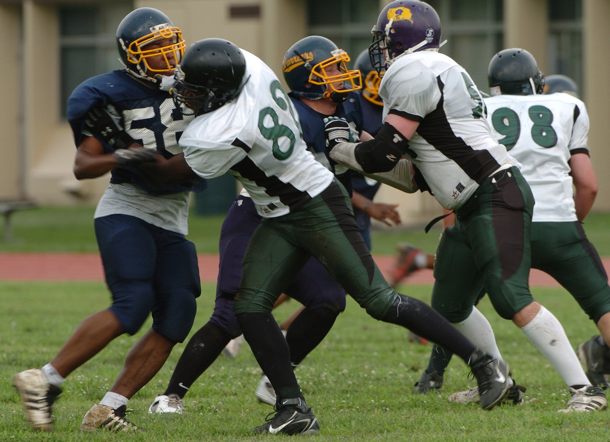 YOKOTA AIR BASE, Japan -- Yokota Warriors' defensive linemen battle against a solid Misawa Jets' offensive line during the first quarter of Yokota's 44-12 defeat of the Jets July 18 in the first round of the U.S. Forces Japan-American Football League playoffs at Bonk Field. Yokota struggled to get pressure on Jets' quarterback Daron Frierson, who went 31-47 for 315 yards and two touchdowns in a losing effort. The Warriors scored three defensive touchdowns in the first half to put the game out of reach early. Yokota travels to Yokosuka Aug. 1 to take on the Seahawks at 7 p.m. (U.S. Air Force photo/Master Sgt. Matt Summers)
