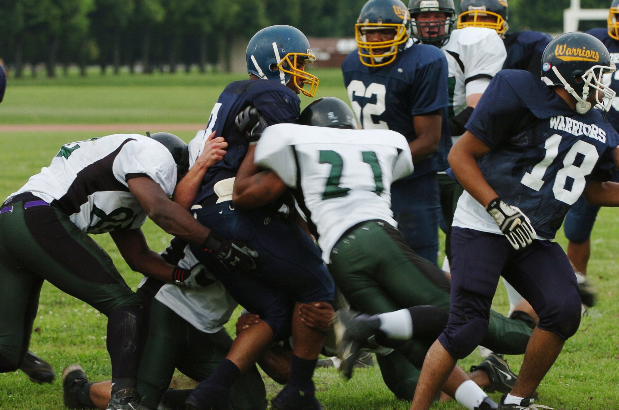 YOKOTA AIR BASE, Japan -- Yokota Warriors' quarterback Ryan Jones drags four Misawa Jets' defenders into the end zone in the first quarter of Yokota's 44-12 defeat of the Jets July 18 in the first round of the U.S. Forces Japan-American Football League playoffs at Bonk Field. The Warriors scored three defensive touchdowns in the first half to put the game out of reach early. Yokota travels to Yokosuka Aug. 1 to take on the Seahawks at 7 p.m. (U.S. Air Force photo/Master Sgt. Matt Summers)