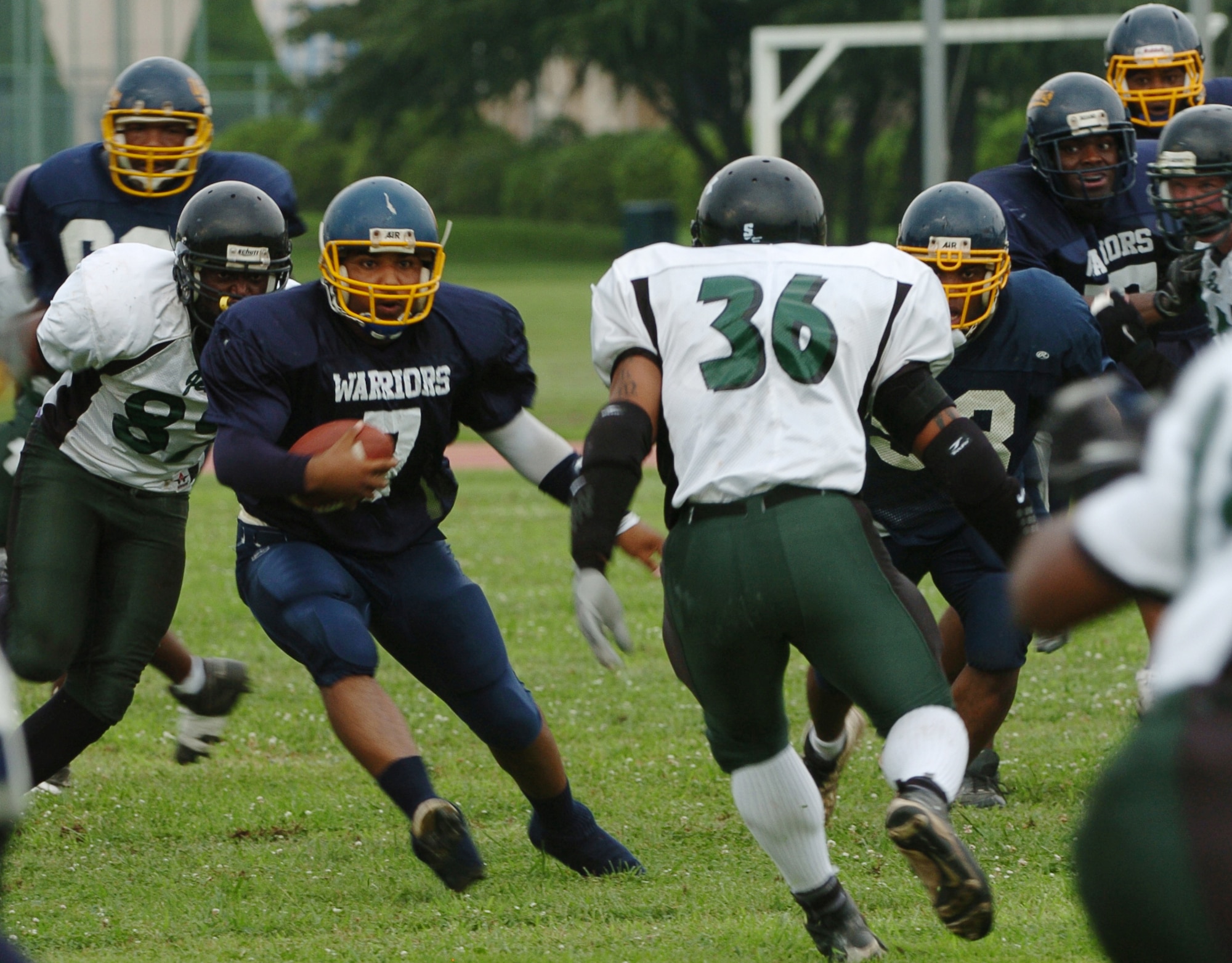 YOKOTA AIR BASE, Japan -- Yokota Warriors' quarterback Ryan Jones looks for running room during Yokota's 44-12 defeat of the Misawa Jets July 18 in the first round of the U.S. Forces Japan-American Football League playoffs at Bonk Field. The Warriors scored three defensive touchdowns in the first half to put the game out of reach early. Yokota travels to Yokosuka Aug. 1 to take on the Seahawks at 7 p.m. (U.S. Air Force photo/Master Sgt. Matt Summers)
