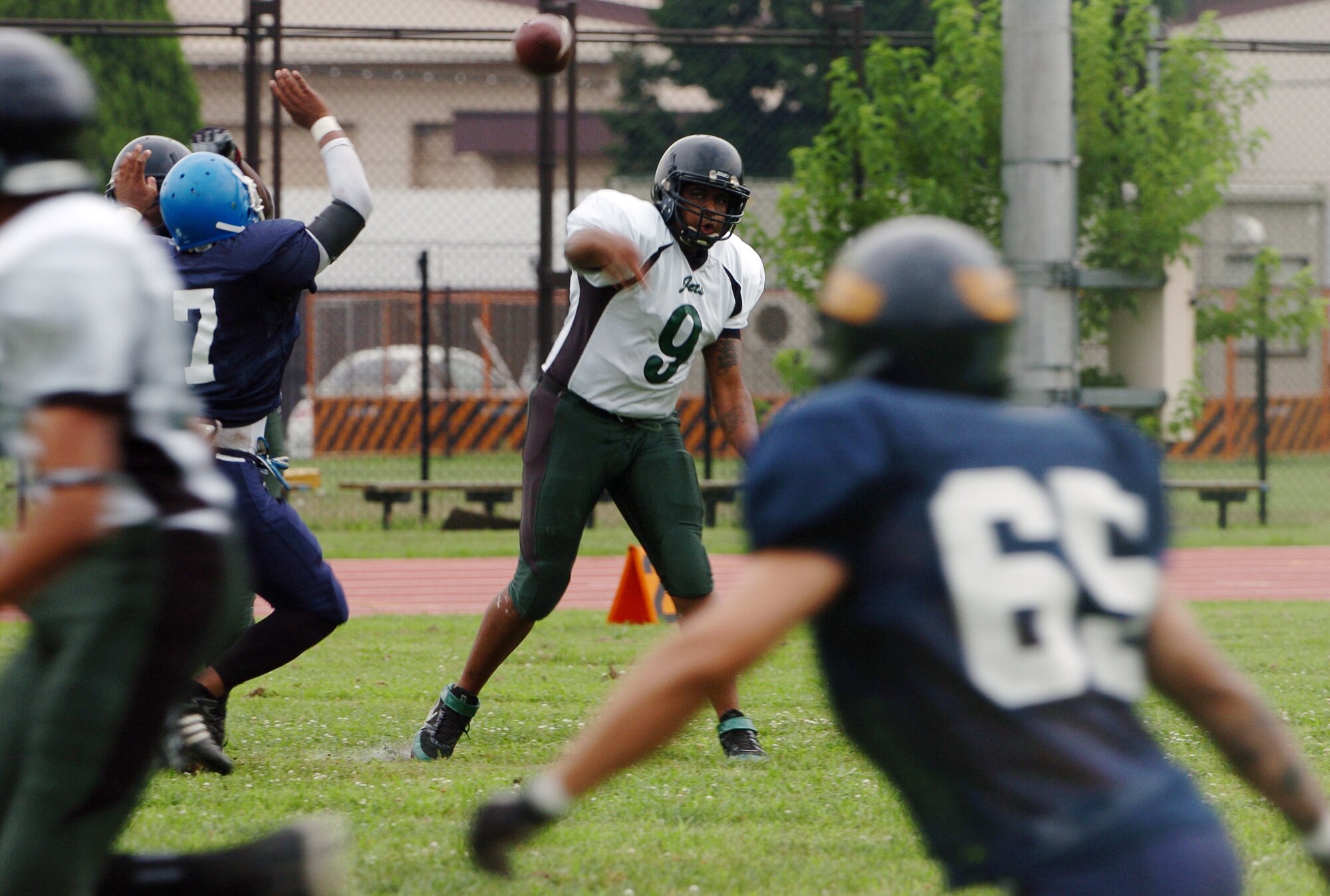 YOKOTA AIR BASE, Japan -- Misawa Jets' quarterback Daron Frierson looks downfield during the first quarter of Yokota's 44-12 defeat of the Jets July 18 in the first round of the U.S. Forces Japan-American Football League playoffs at Bonk Field. Frierson was 31-47 for 315 yards and two touchdowns in a losing effort. The Warriors scored three defensive touchdowns in the first half to put the game out of reach early. Yokota travels to Yokosuka Aug. 1 to take on the Seahawks at 7 p.m. (U.S. Air Force photo/Master Sgt. Matt Summers)