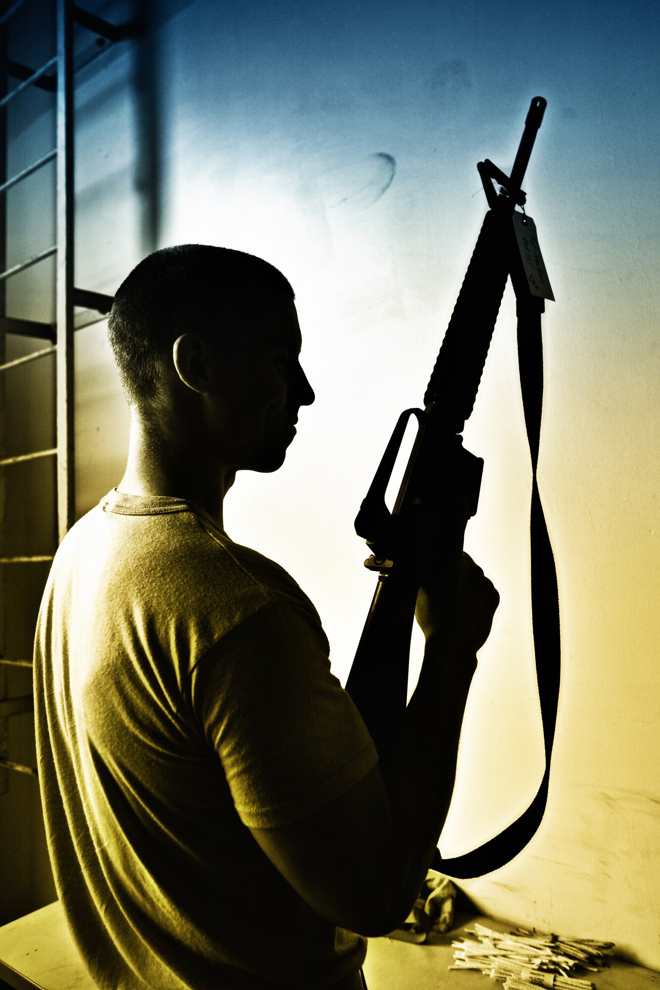 YOKOTA AIR BASE, Japan -- Airman 1st Class Bruce Parker, 374th Logistics Readiness Squadron, inspects an M-16 rifle in the squadron's mobility warehouse to ensure the weapon is not loaded before cleaning it July 20. The 374th LRS Individual Protective Equipment Issue Section maintains and provides equipment to Yokota Airmen for use during training exercises and real-world deployments. (U.S. Air Force photo/Osakabe Yasuo)