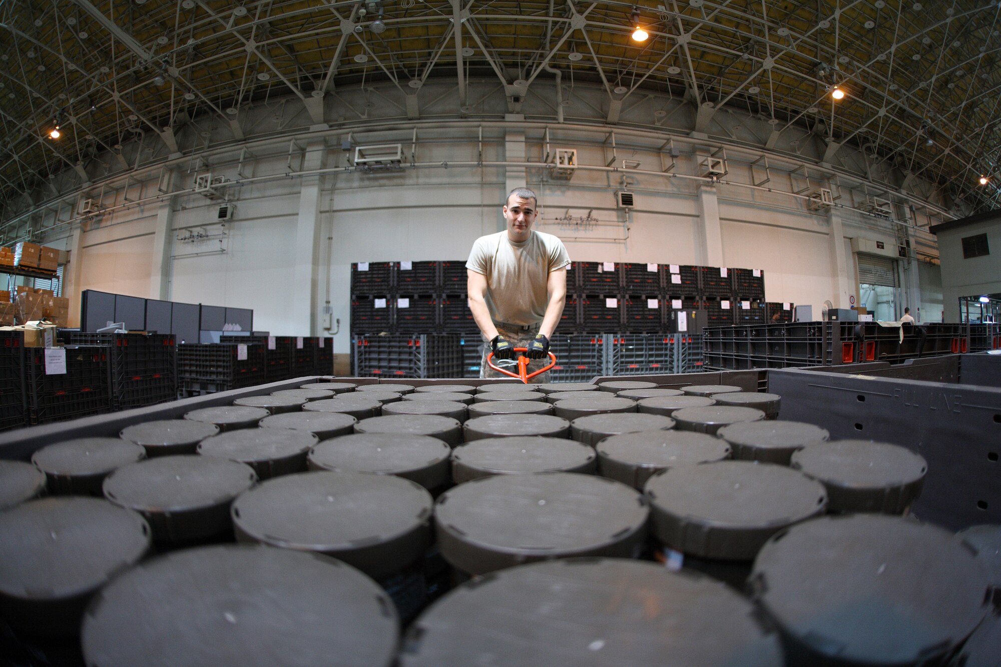 YOKOTA AIR BASE, Japan -- Airman 1st Class Kevin Kirk, 374th Logistics Readiness Squadron loads a pallet of C2A1 filter canisters in the squadron's mobility warehouse July 20. Airman Kirk works in the individual protective equipment issue section and maintains IPE for training and real-world deployments. (U.S. Air Force photo/Osakabe Yasuo)