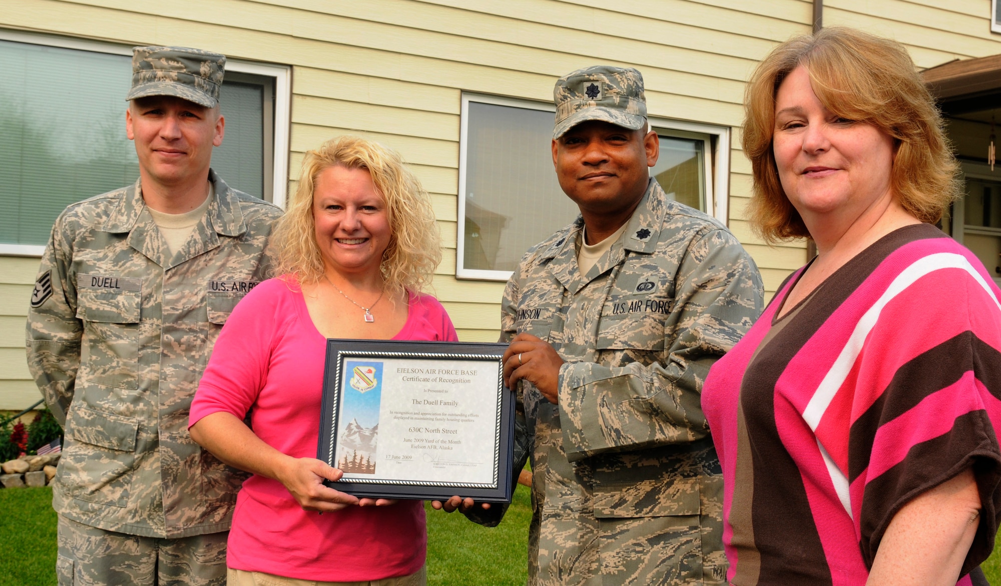 Staff Sgt. Michael Duell and wife Stephanie display their Home Your Proud of Award with Lt. Col Jesse Johnson, and Lorie Dallas, July 14, 2009 Eielson Air Force Base, Alaska. Sergeant Duell and his family are winners for area 2. Each winning houshold recieved gift cards from variouse units off base. Sergeant Duell is with the 354th Comptrollers Squadron, Colonel Johnson is the 354th Mission Support Group deputy commander, and Ms. Dallas, 354th CES military family housing chief of capital asset management. (U.S. Air Force photo/Airman 1st Class Laura Goodgame)