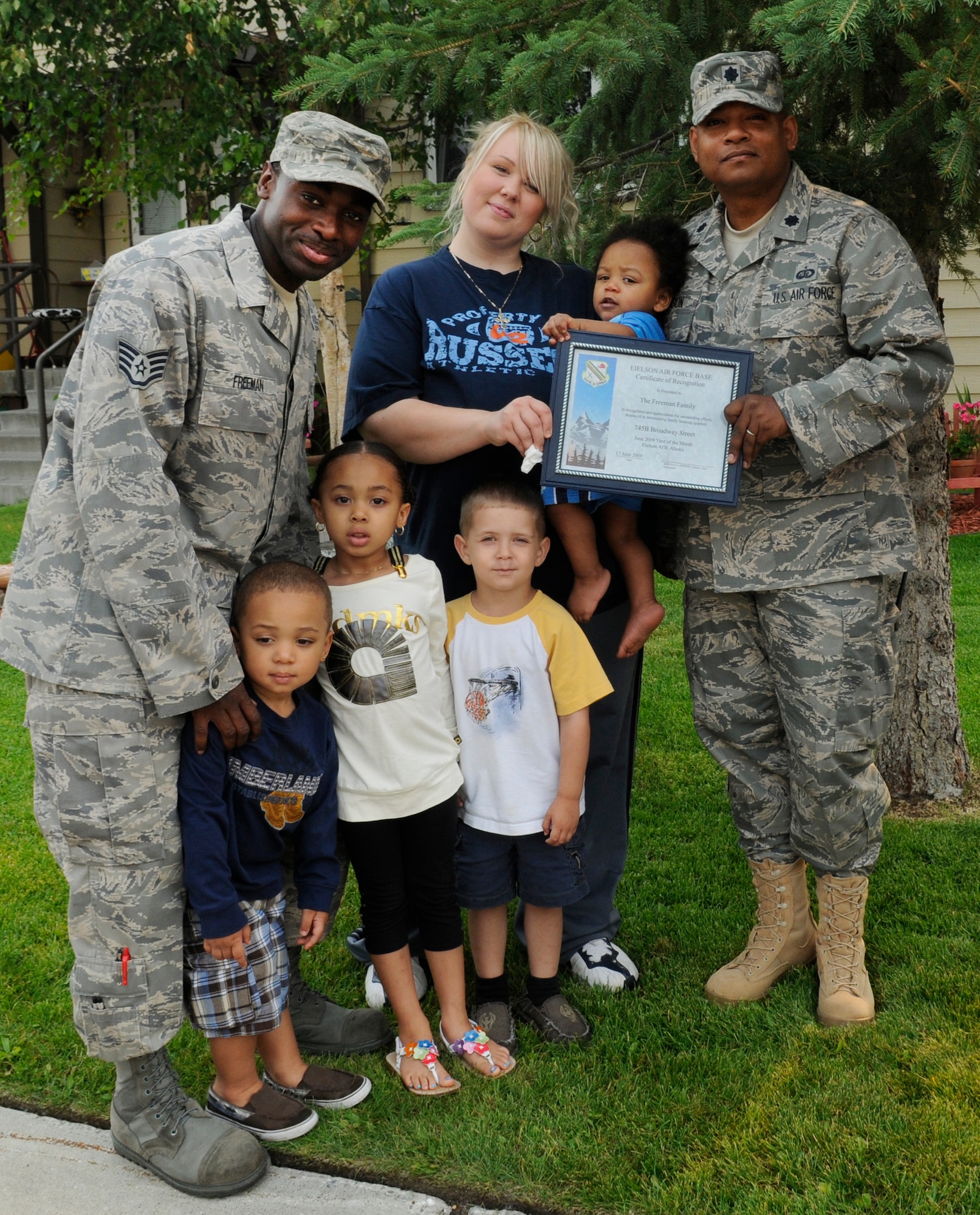 The Freeman family display their Home Your Proud of Award with Lt. Col. Jesse Johnson, and Lorie Dallas, July 14, 2009 Eielson Air Force Base, Alaska. Sergeant Freeman and his family are winners for area 3. Each winning houshold recieved gift cards from variouse units off base. Staff Sgt Ashley Freeman is with the Aircraft Maintenance Squadron, Colonel Johnson is the 354th Mission Support Group deputy commander, and Ms. Dallas, 354th CES military family housing chief of capital asset management. (U.S. Air Force photo/Airman 1st Class Laura Goodgame)