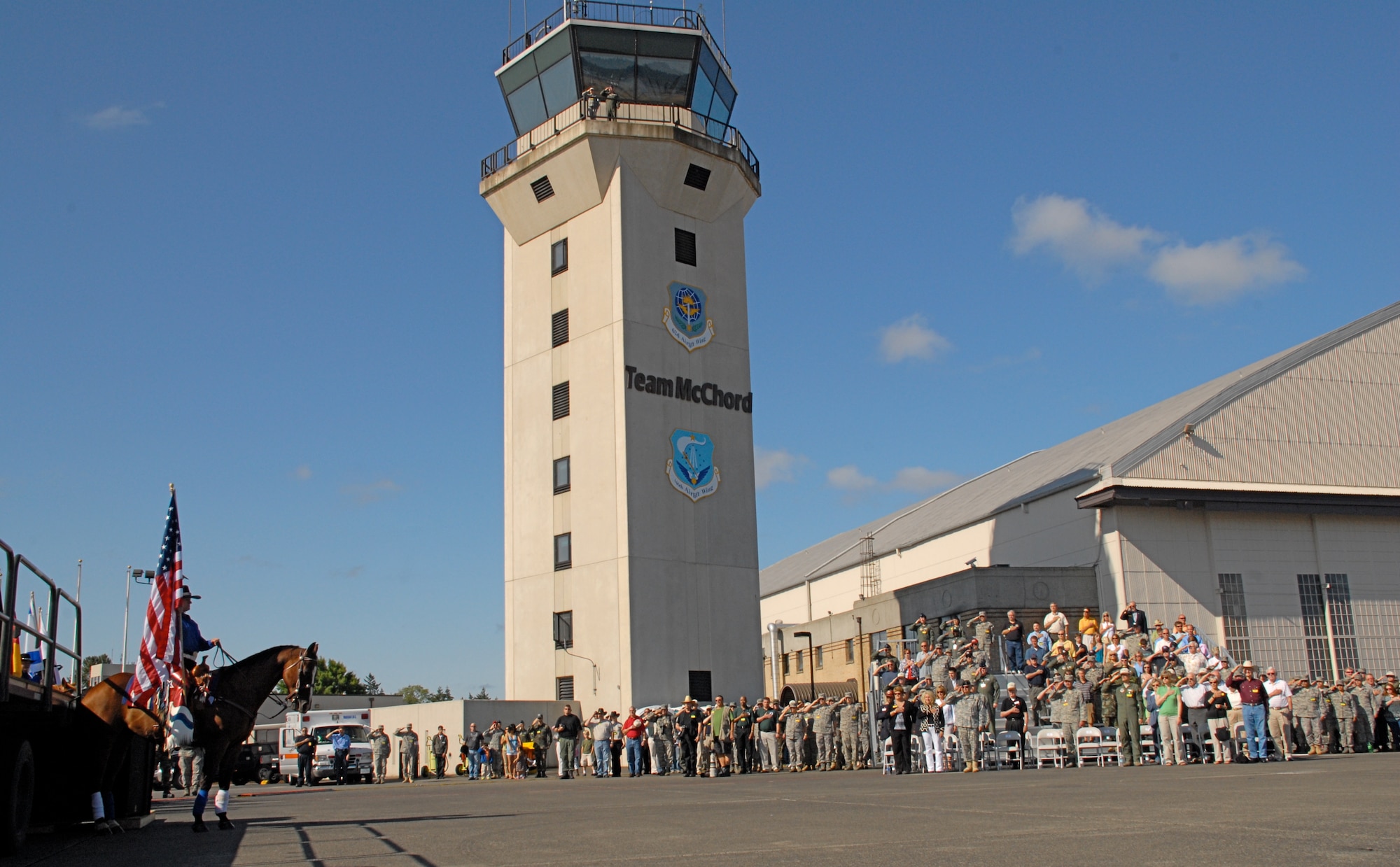 MCCHORD AIR FORCE BASE, Wash. -- Rodeo participants and spectators salute the U.S. flag on the flightline of McChord Air Force Base, Wash., July 19. The rodeo is designed to demonstrate air mobility mission capabilities, seek out new tactics, techniques, and procedures that improve mission results, increase esprit de corps both among competing teams and internationally, and build standardization and safety. (U.S. Air Force photo/Staff Sgt. Carolyn Viss)