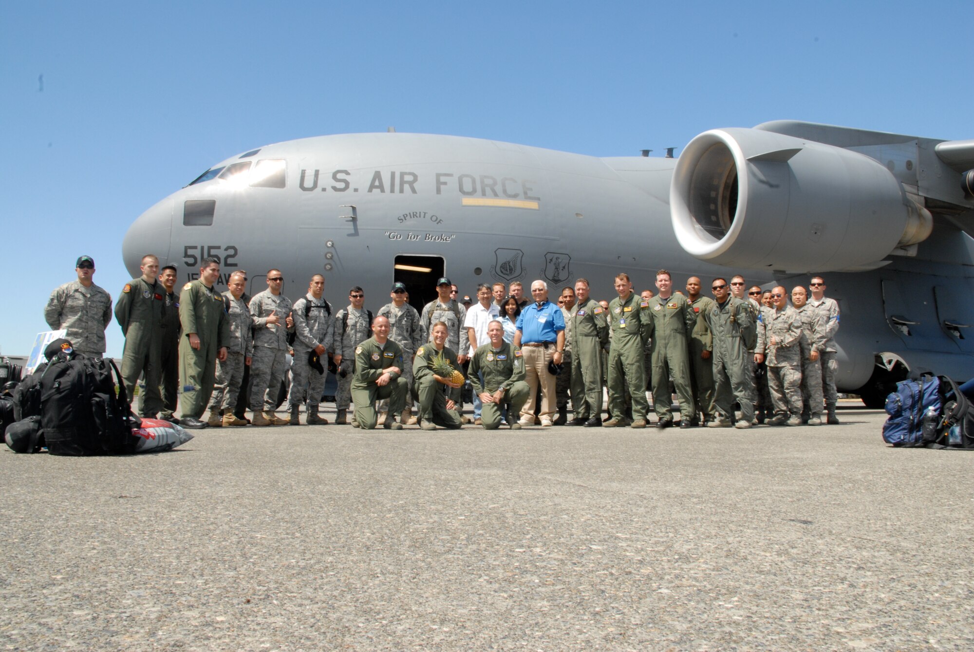 MCCHORD AIR FORCE BASE, Wash. -- Team Hickam's 15th Airlift Wing and 515th Air Mobility Operations Wing competitors arrive at McChord AFB July 18 for the Air Mobility Rodeo 2009. Accompanying the Rodeo team are Steve Wood and Friends of Hickam members Anthony Ramos and Quan Nguyen. The Air Mobility Rodeo, held every two years, provides an excellent opportunity in both a friendly and competitive environment for forces from around the world to come together in order to hone necessary skills to successfully execute Air Mobility operations. (U.S. Air Force photo/Staff Sgt. Carolyn Viss)