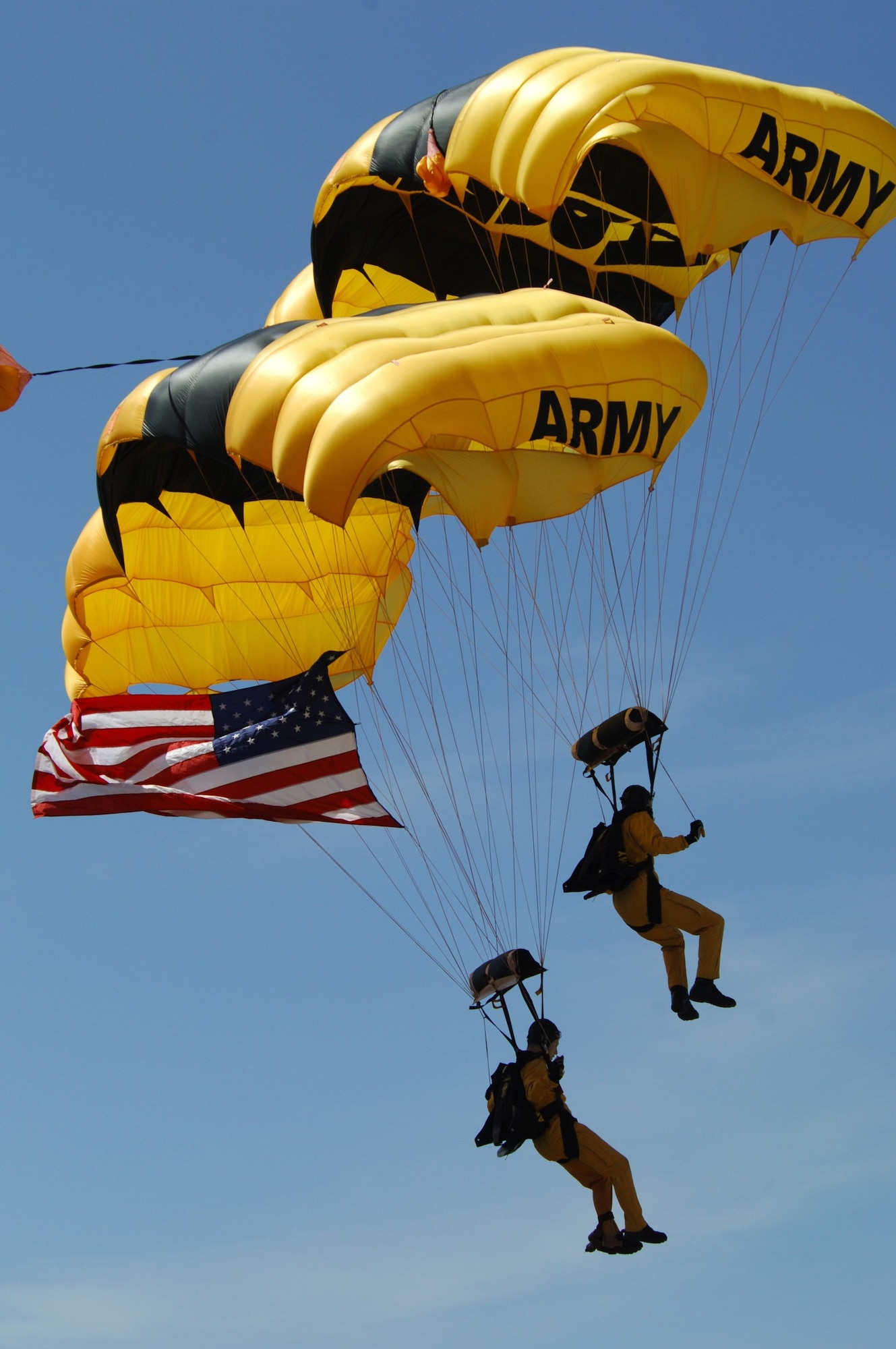 MINOT AIR FORCE BASE, N.D. -- Members from the U.S. Army Golden Knight parachute team descends on Minot displaying the American flag during the 2009 Northern Neighbors Day opening ceremony here July 18. Thousands of people from the base and local community turned out to watch the 2009 Northern Neighbors Day, which came through on its promise to wow spectators with amazing aerial maneuvers, nail-biting choreography, historic displays and much more.   (U.S. Air Force photo by Tech. Sgt.  Lee A. Osberry Jr.)