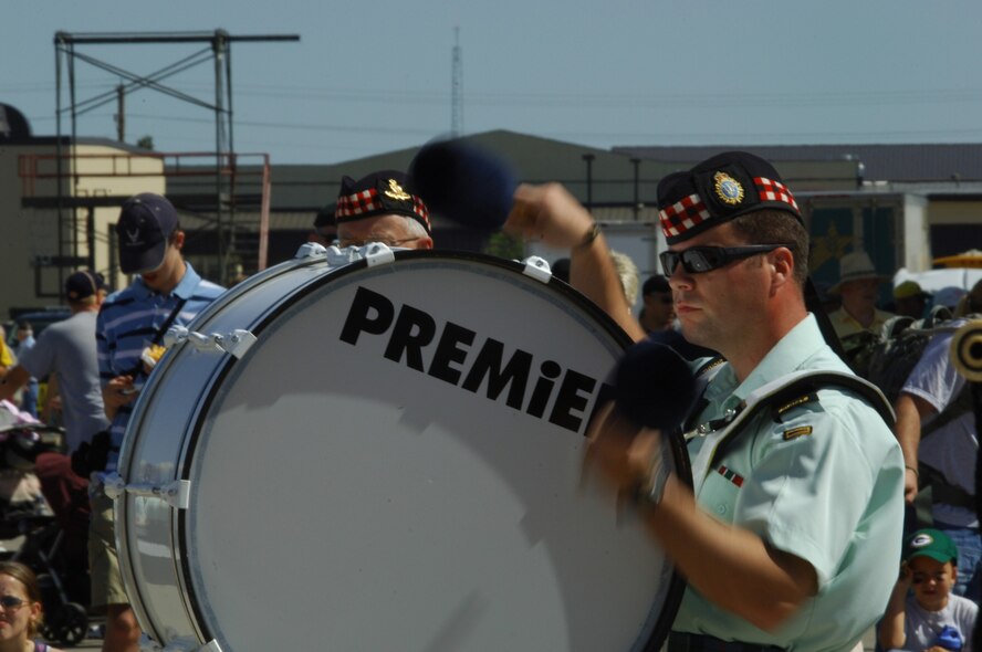 MINOT AIR FORCE BASE, N.D. -- Jeff Jordan, Royal Canadian Artillery  Pipes and Drums 26th Field Regiment, skillfully plays the drum with fellow bagpipers in a selection during the 2009 Northern Neighbors Day festivities here July 18. Thousands of people from the base and local community turned out to watch the 2009 Northern Neighbors Day, which came through on its promise to wow spectators with amazing aerial maneuvers, nail-biting choreography, historic displays and much more.   (U.S. Air Force photo by Tech. Sgt.  Lee A. Osberry Jr.)