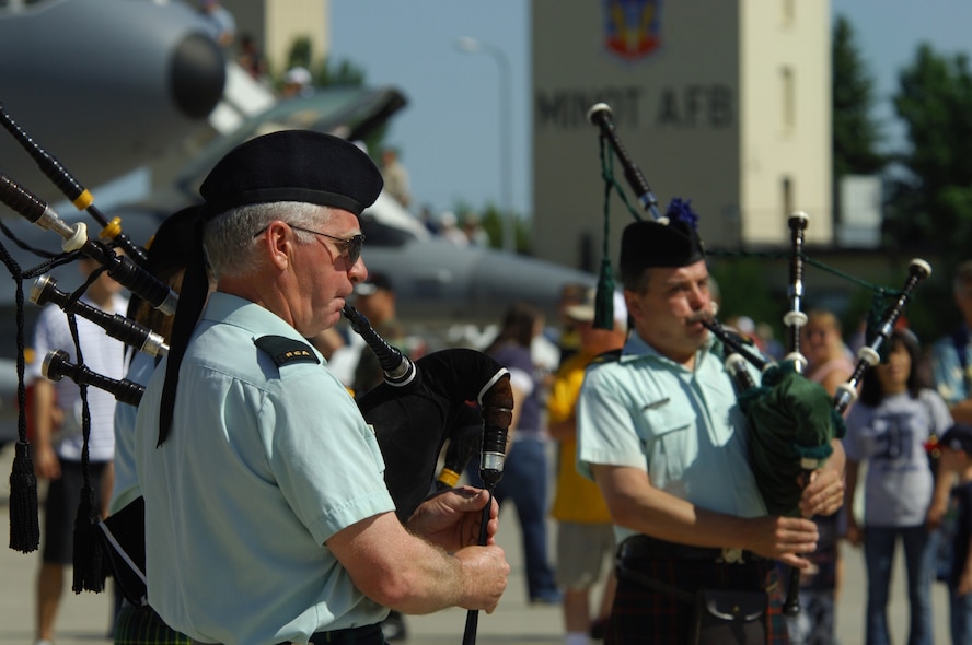 MINOT AIR FORCE BASE, N.D. -- Jamie McFadden, Royal Canadian Artillery Pipes and Drums, 26th Field Regiment leads fellow bagpipers in a selection during the 2009 Northern Neighbors Day festivities here July 18. Thousands of people from the base and local community turned out to watch the 2009 Northern Neighbors Day, which came through on its promise to wow spectators with amazing aerial maneuvers, nail-biting choreography, historic displays and much more.   (U.S. Air Force photo by Tech. Sgt.  Lee A. Osberry Jr.)