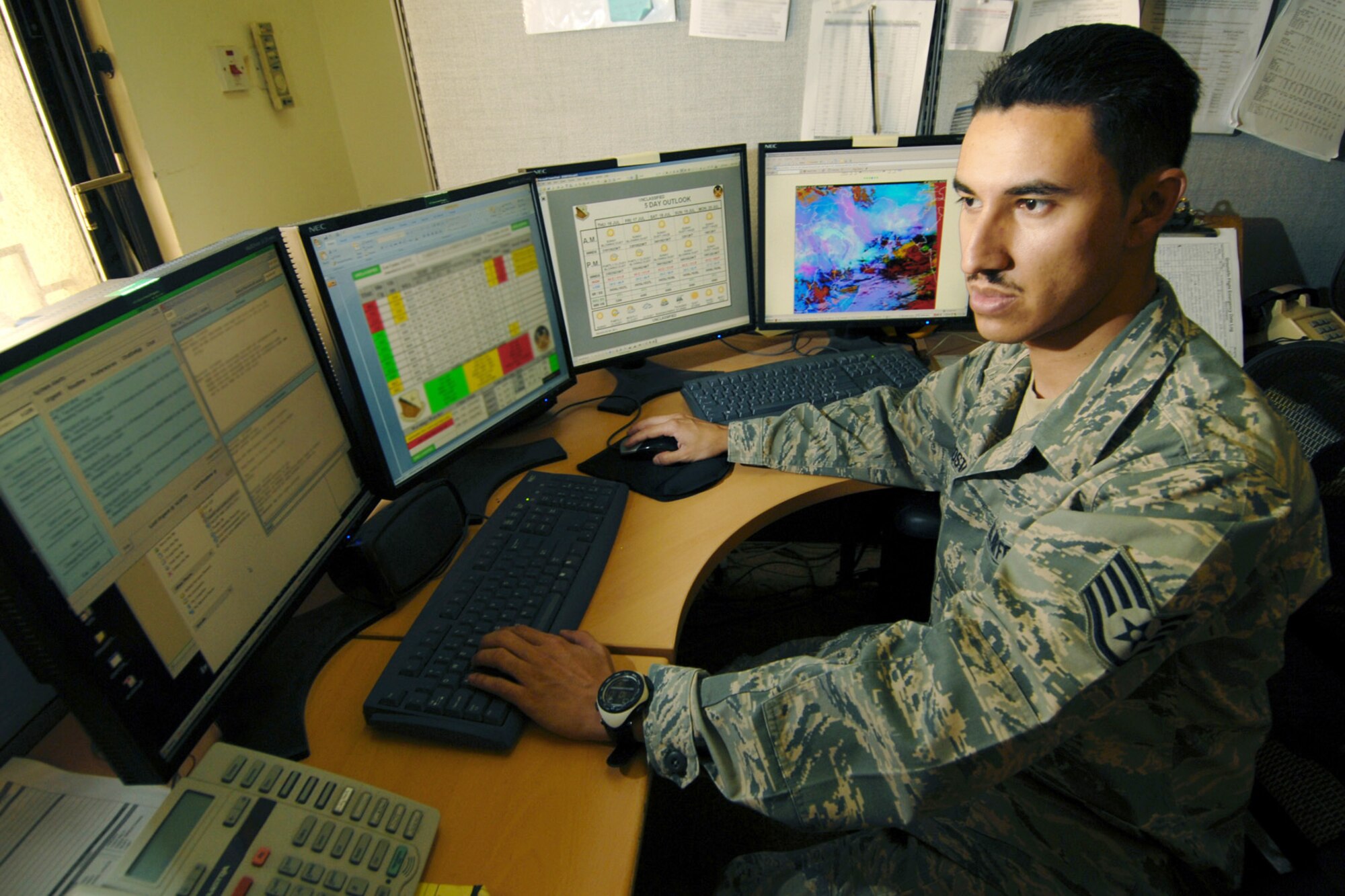 Staff Sgt. Esteban Acosta, a forecaster in the 379th Expeditionary Operations Support Squadron Weather Flight, observes weather conditions and issues weather advisories, watches, and warnings at an air base in Southwest Asia. The forecasters provide around-the-clock weather service in support of coalition ground and air forces in Southwest Asia. Sergeant Acosta is deployed from Yokota Air Base, Japan. (U.S. Air Force Photo/Tech Sgt. Jason W. Edwards)