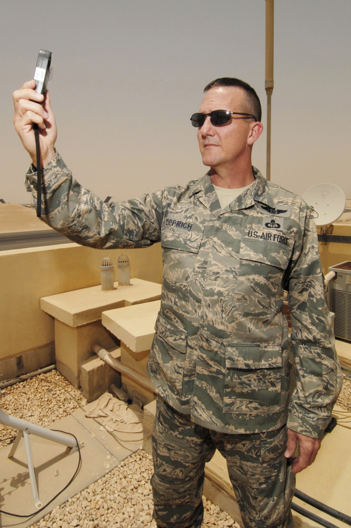 Senior Master Sgt. Tom Zipprich, the 379th Expeditionary Operations Support Squadron Weather Flight superintendent at an air base in Southwest Asia, records a tactical weather observation July 13 using a Kestrel hand held-weather observation device.  The forecasters provide around-the-clock weather service in support of coalition ground and air forces in Southwest Asia.  Sergeant Zipprich is deployed from Dyess Air Force Base, Texas.  (U.S. Air Force Photo/Tech Sgt. Jason W. Edwards)