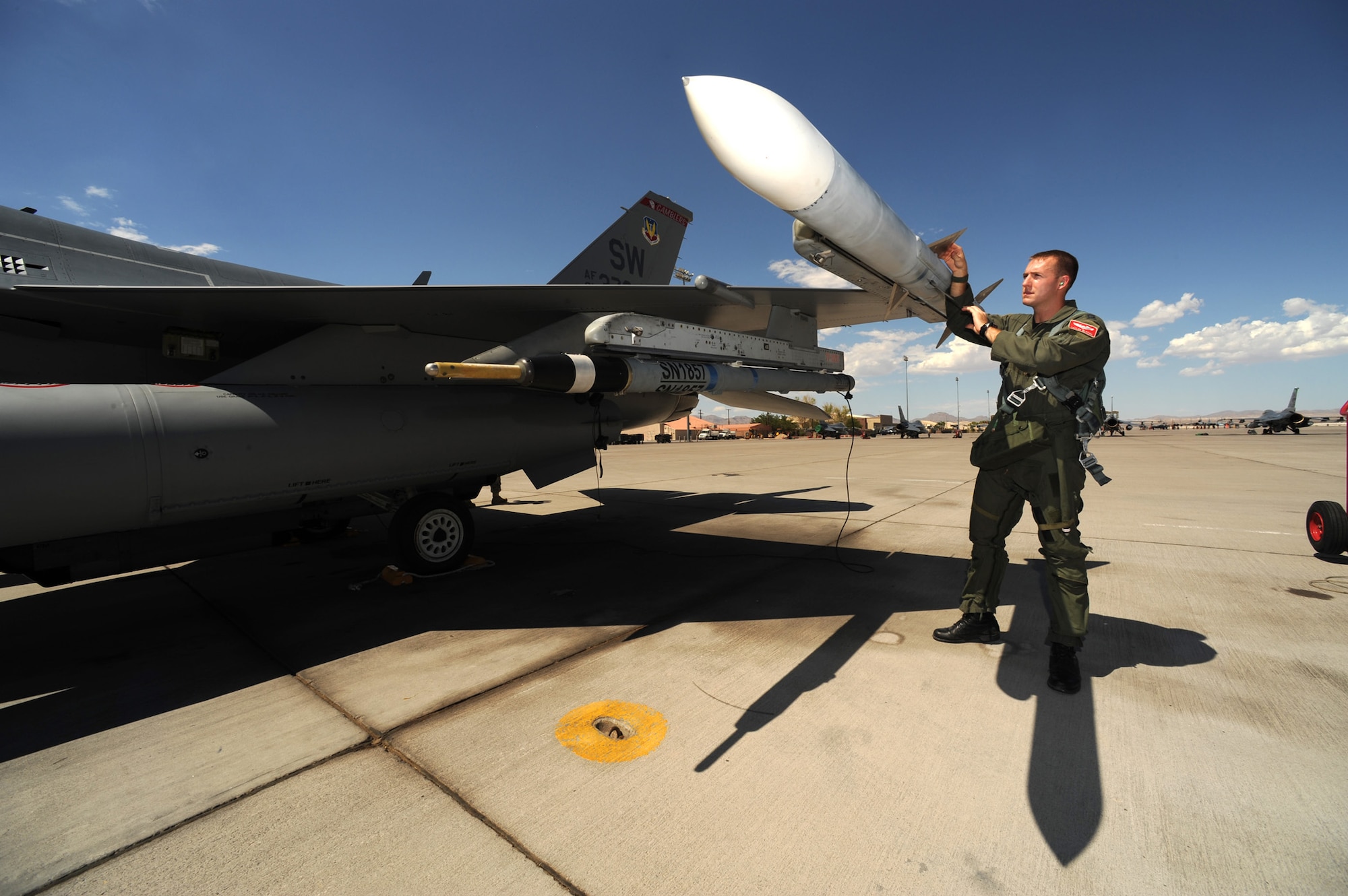 Capt. Taylor Blevins, 77th Fighter Squadron conducts pre-flight checks on an F-16CJ  before departing on a training mission at Red Flag 09-4, Nellis Air Force Base, Nev.,  July 16, 2009. Red Flag is a highly-realistic combat training exercise that pits U.S. and allied nation air forces against 'enemy' forces in a challenging air, ground, cyberspace and electronic threat environment. (U.S. Air Force Photo/Tech. Sgt. Michael R. Holzworth)

