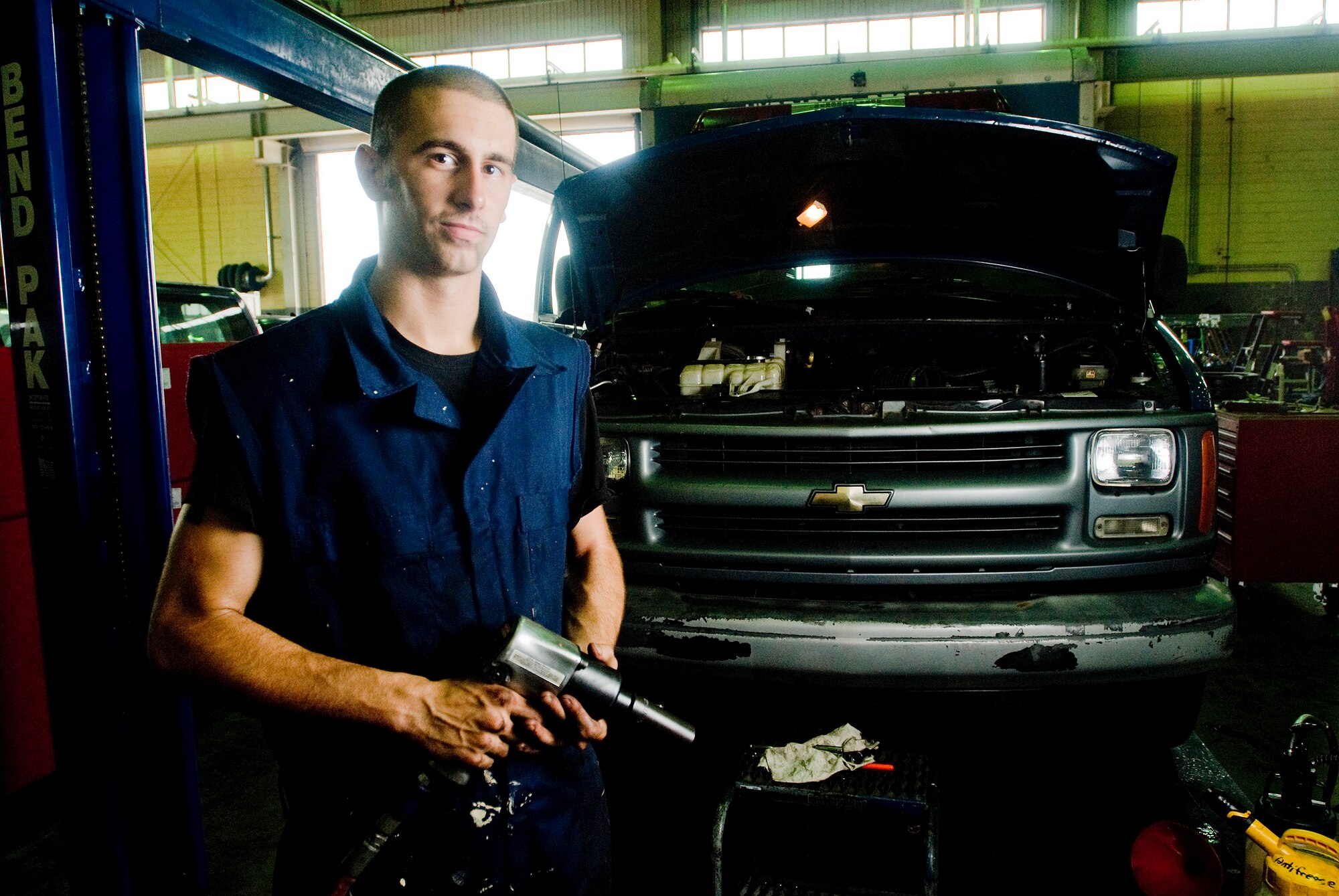 Airman 1st Class Christopher Smith stops for a second for a photo after working on the vehicle behind him all day long at Kunsan Air Base, Republic of Korea July 16. Airman Smith is vehicle maintainer from the 8th Logistics Readiness Squadron, who is responsible for the upkeep of all vehicles on Kunsan Air Base. (U.S. Air Force Photo/Senior Airman Jonathan Steffen)