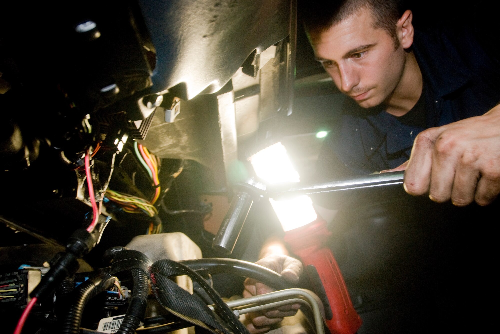 Airman 1st Class Christopher Smith reaches into  the engine compartment to replace the thermostat at Kunsan Air Base, Republic of Korea July 16. Airman Smith is a vehicle maintainer from the 8th Logistics Readiness Squadron, who is responsible for the upkeep of all vehicles on Kunsan Air Base. (U.S. Air Force Photo/Senior Airman Jonathan Steffen)