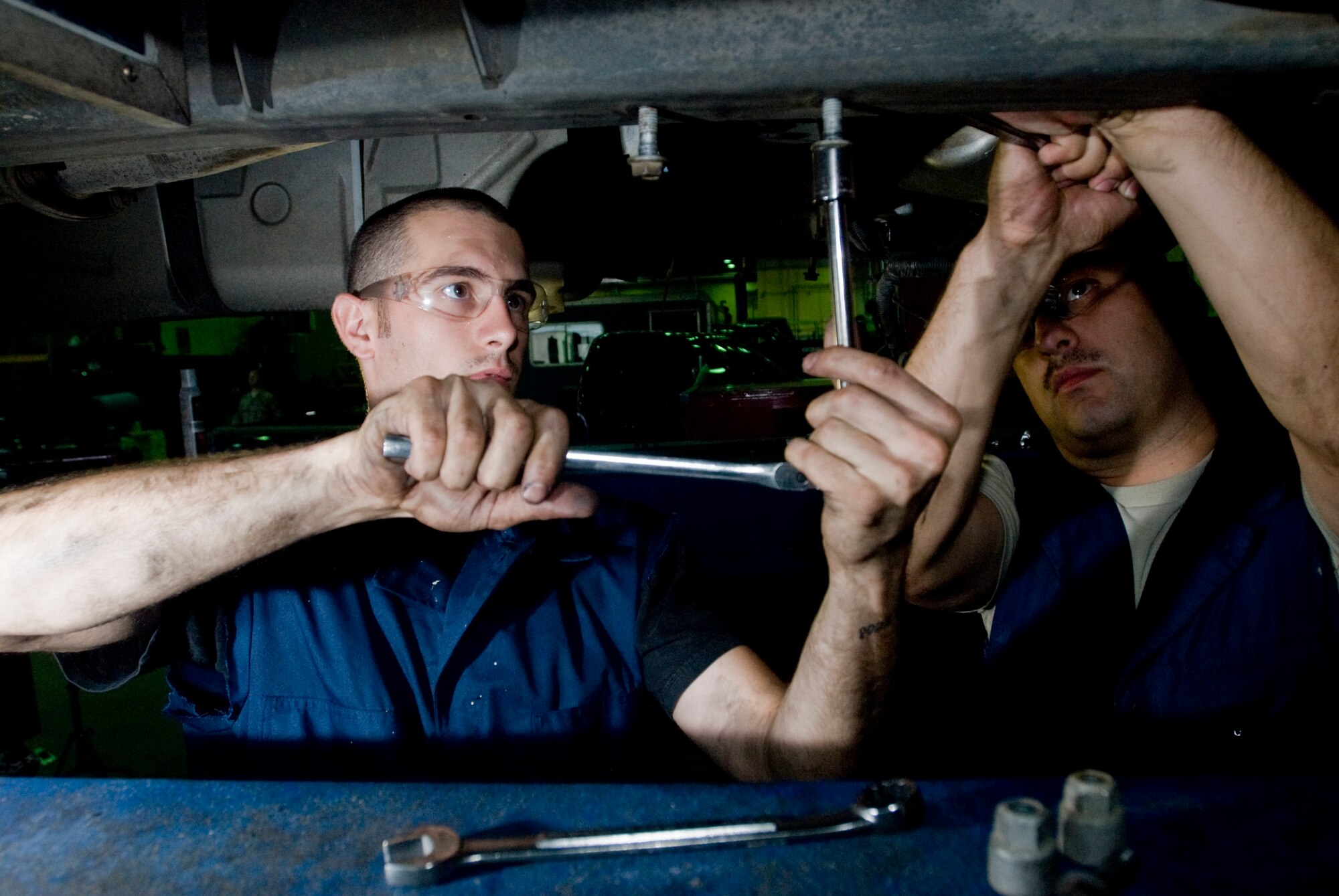 Airman 1st Class Christopher Smith and Senior Airman Arturo Vega bolts up the crossbar at Kunsan Air Base, Republic of Korea July 16. Airmen Vega and Smith are both vehicle maintainers from the 8th Logistics Readiness Squadron who are responsible for the upkeep of all vehicles on Kunsan Air Base. (U.S. Air Force Photo/Senior Airman Jonathan Steffen)