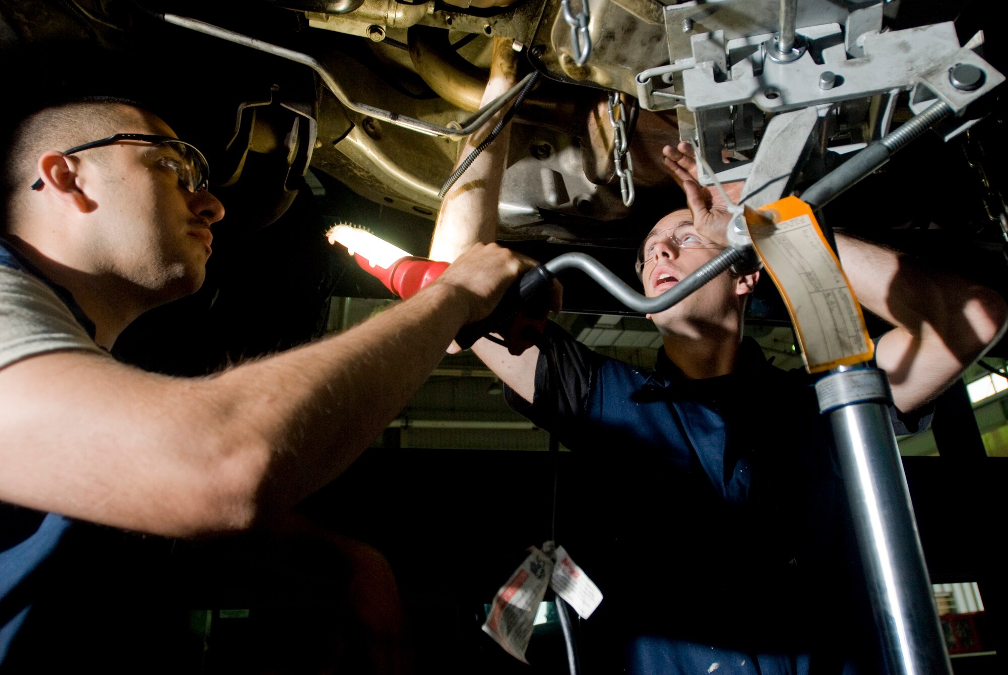 Senior Airman Arturo Vega and Airman 1st Class Christopher Smith work on replacing the rear main sill on a transmission at Kunsan Air Base, Republic of Korea July 16. Airmen Vega and Smith are vehicle maintainers from the 8th Logistics Readiness Squadron who are responsible for the upkeep of all vehicles on Kunsan Air Base. (U.S. Air Force Photo/Senior Airman Jonathan Steffen)