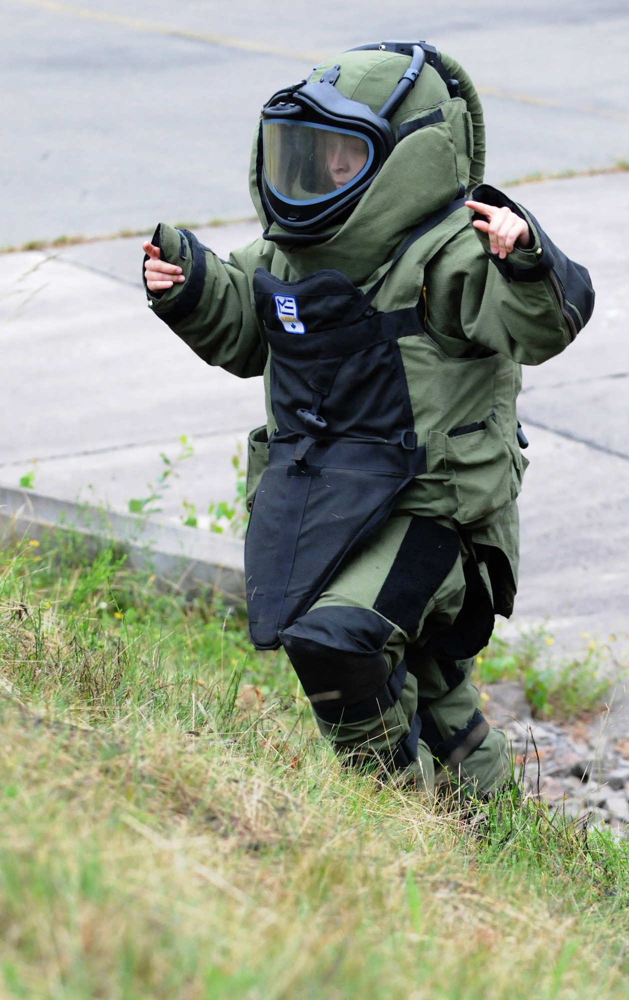 Royal Air Force Air Cadet Cpl. Charlotte Bennetts climbs a hill in an explosive ordnance disposal bomb suit that weighs approximately 75 lbs. during a July 14 visit to Ramstein Air Base, Germany. RAF cadets visited Ramstein AB for a week of leadership development and contingency skills training. (U.S. Air Force photo/Senior Airman Nathan Lipscomb) 