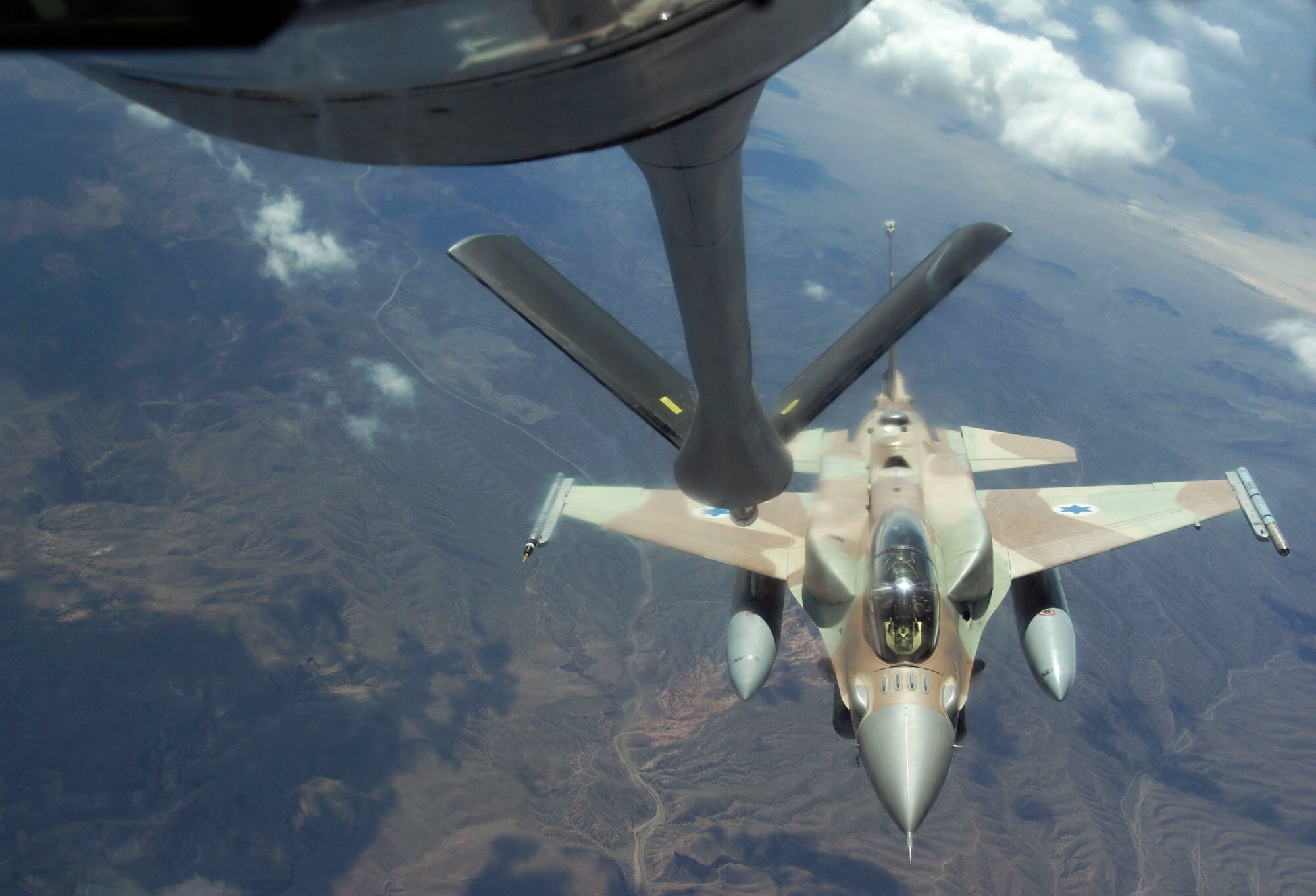 An Israeli Air Force F-16 from Ramon Air Base, Israel, moves into refueling position July 17, 2009 over the Nevada Test and Training Range during Red Flag 09-4.  Red Flag is a realistic combat training exercise involving the air forces of the United States and its allies. The exercise is conducted on  the 15,000-square-mile Nevada Test and Training Range, north of Las Vegas. Red Flag is one of a series of advanced training programs administered by the U.S. Air Force Warfare Center and Nellis, through the 414th Combat Training Squadron. Flying for Red Flag 09-4 begins July 13 and ends July 24. Red Flag is a realistic combat training exercise involving the air forces of the United States and its allies. The exercise is conducted on the 15,000-square-mile Nevada Test and Training Range, north of Las Vegas. Red Flag is one of a series of advanced training programs administered by the U.S. Air Force Warfare Center and Nellis, through the 414th Combat Training Squadron. Flying for Red Flag 09-4 began July 13 and ends July 24. Units participating in 09-4 are from Nellis and Creech in Nevada, South Carolina, Idaho, the United Kingdom, Washington, Oklahoma and Ohio. Aircraft types include F-15s, F-16s, E-3s and KC-135s. In addition to U.S. aircraft, the Israeli Air Force will be flying F-16C Falcons.

(U.S. Air Force photo/ Master Sgt. Kevin J. Gruenwald) released
