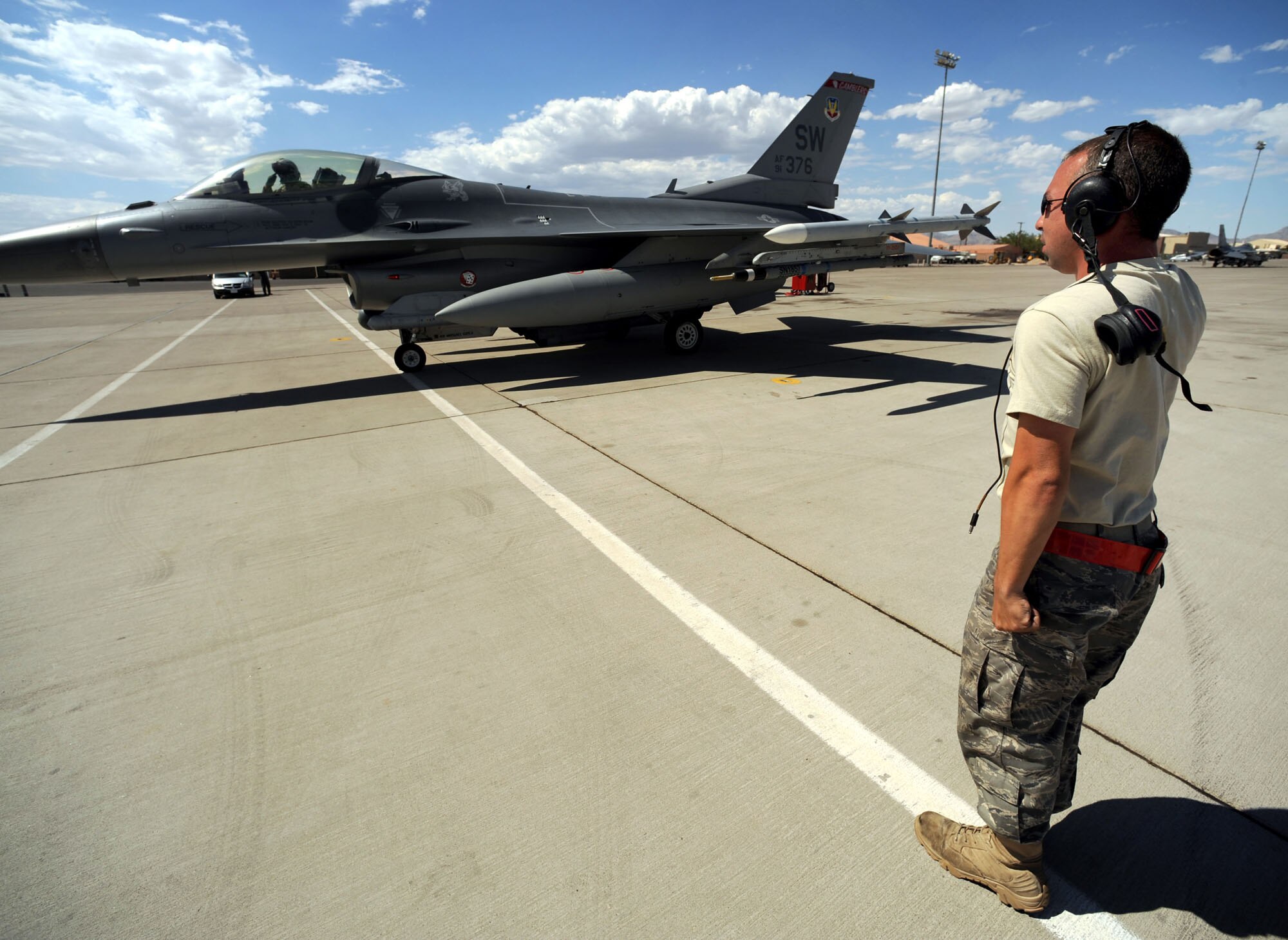 Capt. Taylor Blevins, 77th Fighter Squadron returns a final salute from Staff Sgt. William Reeder before departing for a training mission at Red Flag 09-4, Nellis Air Force Base, Nev.,  July 16, 2009. Red Flag is a highly-realistic combat training exercise that pits U.S. and allied nation air forces against 'enemy' forces in a challenging air, ground, cyberspace and electronic threat environment. (U.S. Air Force Photo/Tech. Sgt. Michael R. Holzworth)