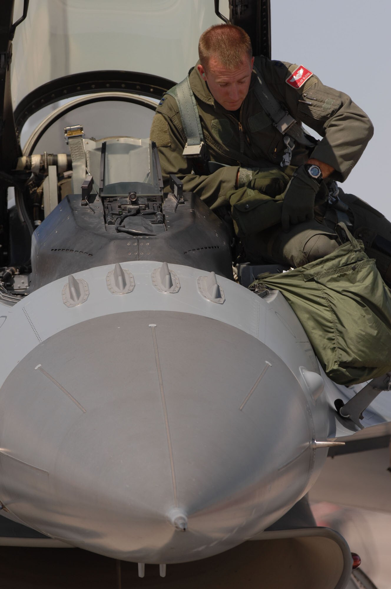 Capt. Taylor Blevins, 77th Fighter Squadron, climbs into an F-16CJ for a training mission at Nellis Air Force Base, Nev., July 16, 2009 during Red Flag 09-4. Red Flag is a highly-realistic combat training exercise that pits U.S. and allied nation air forces against 'enemy' forces in a challenging air, ground, cyberspace and electronic threat environment. (U.S. Air Force Photo/Tech. Sgt. Michael R. Holzworth)

