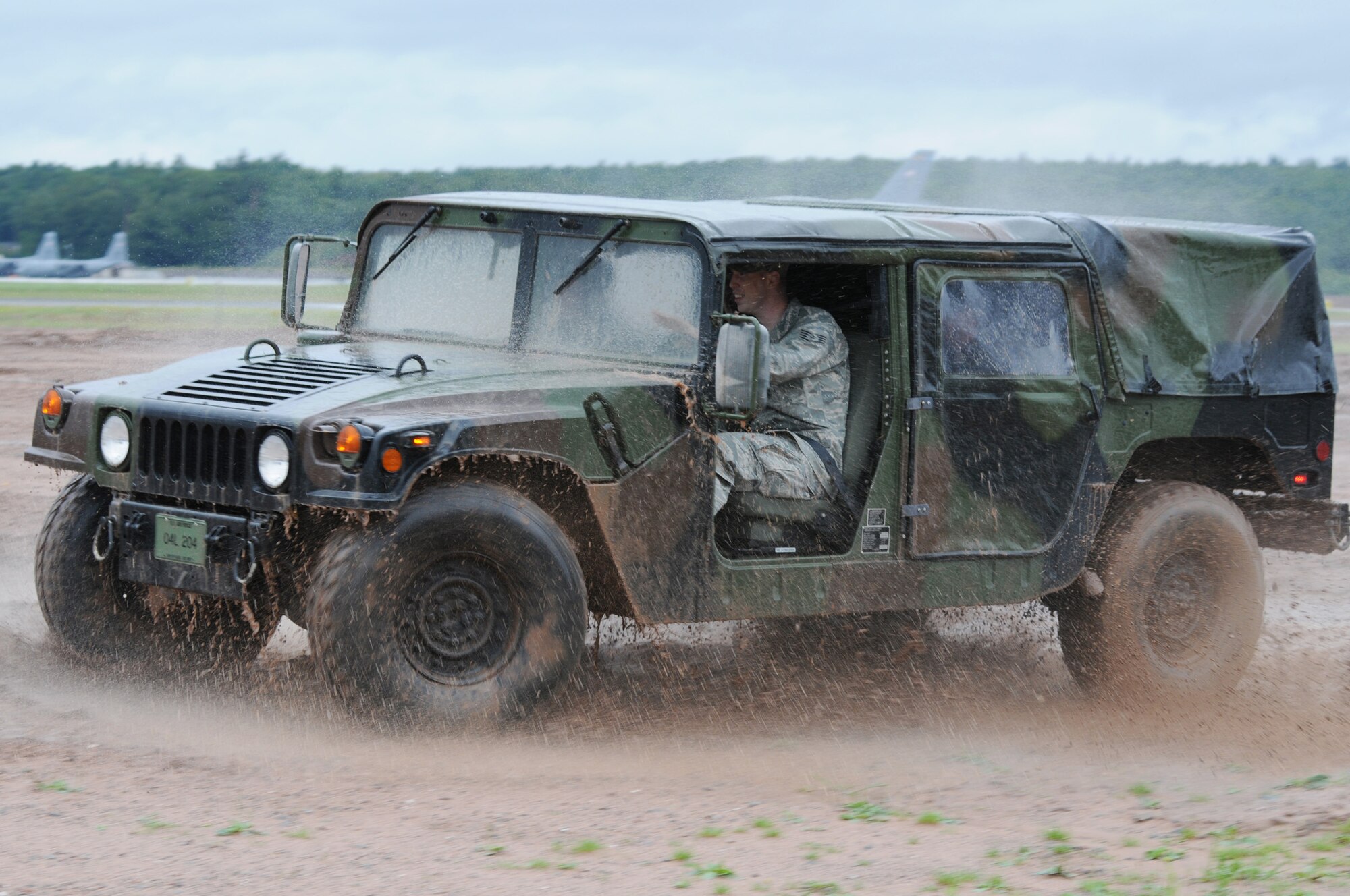 Staff Sgt. Chris Harwood trains Royal Air Force air cadets on Humvee operations during a July 14 visit to Ramstein Air Base, Germany. RAF cadets visited Ramstein AB for a week of leadership development and contingency skills training. Sergeant Harwood is a 86th Construction and Training Squadron instructor. (U.S. Air Force photo/Airman 1st Class Caleb Pierce) 