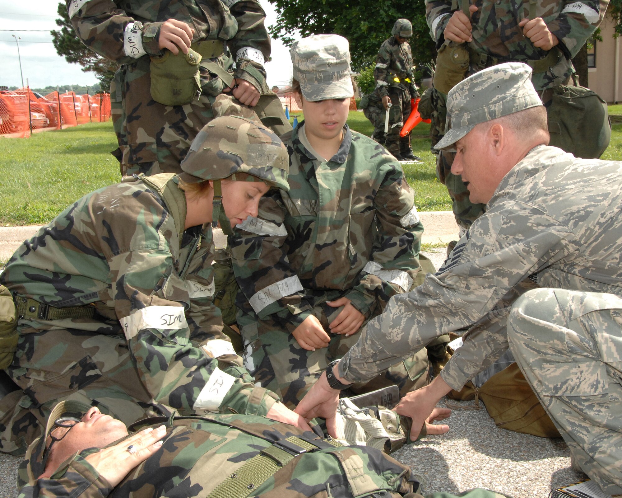 OFFUTT AIR FORCE BASE, Neb. -- Members of Team Offutt, responding to a mock broken arm incident, practice their first aid skills during combat day here July 14. U.S. Air Force Photo by Dana Heard