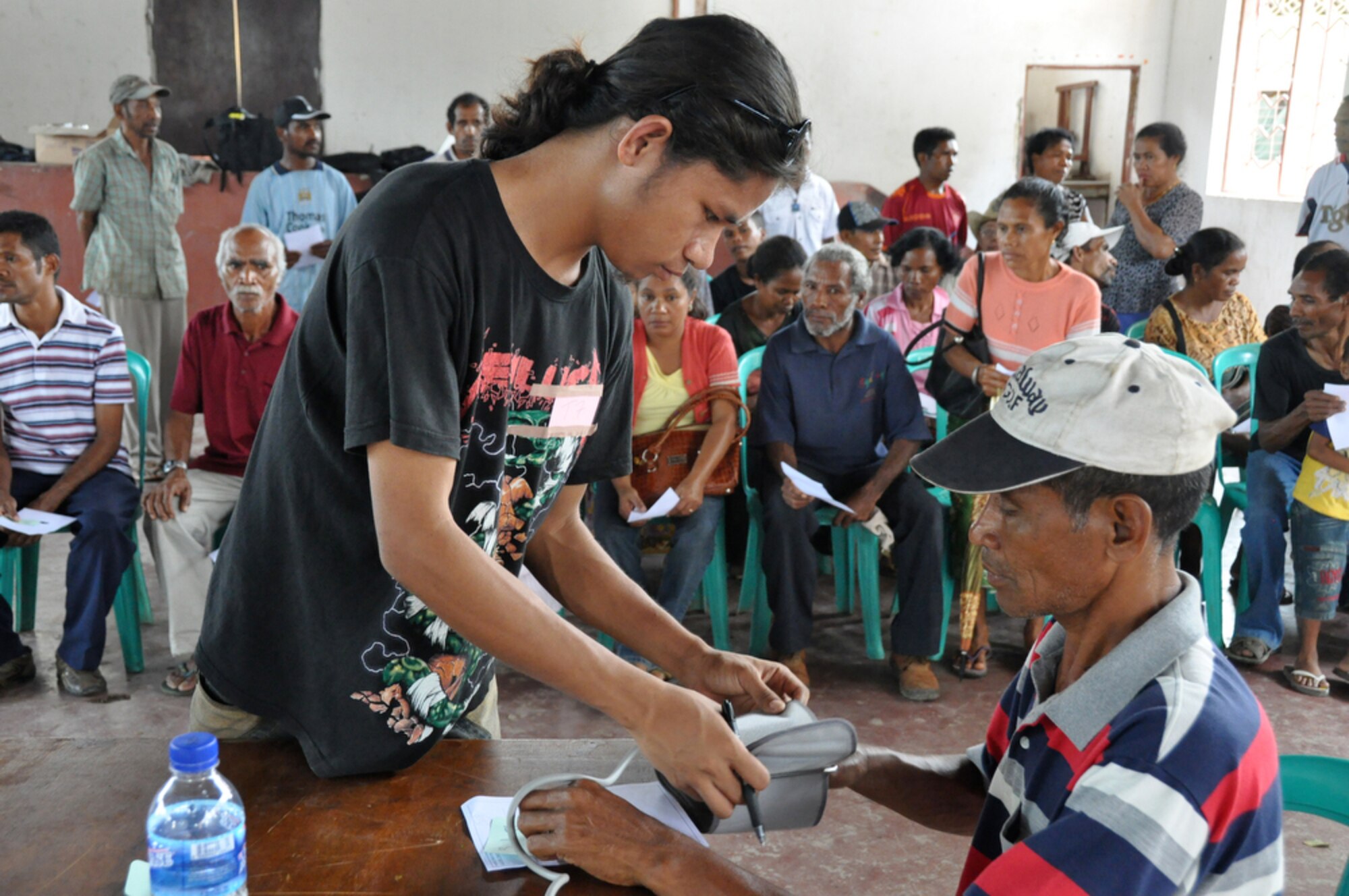 DILI, Timor Leste ? An East Timorese volunteer checks a local man's blood pressure July 20 before sending him to the family care section of a clinic here, set up as part of Operation Pacific Angel 2009. The family care section has seen more than 1,000 East Timorese patients since opening July 16. Pacific Angel is a Pacific Air Forces humanitarian assistance operation in the Asia-Pacific region led by 13th Air Force at Hickam AFB. (U.S. Air Force photo/Tech. Sgt. Cohen A. Young)