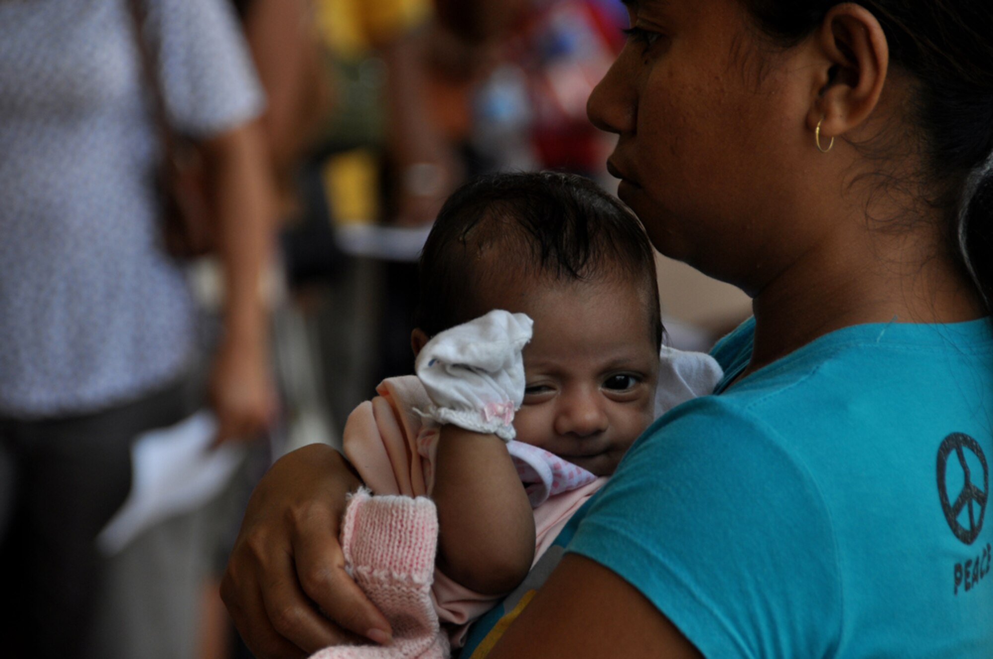 DILI, Timor Leste ? An East Timorese baby stretches July 20 as her mother waits in line outside the family care section of a clinic here, set up as part of Operation Pacific Angel 2009. The family care section has seen more than 1,000 East Timorese patients since opening July 16. Pacific Angel is a Pacific Air Forces humanitarian assistance operation in the Asia-Pacific region led by 13th Air Force at Hickam AFB. (U.S. Air Force photo/Tech. Sgt. Cohen A. Young)