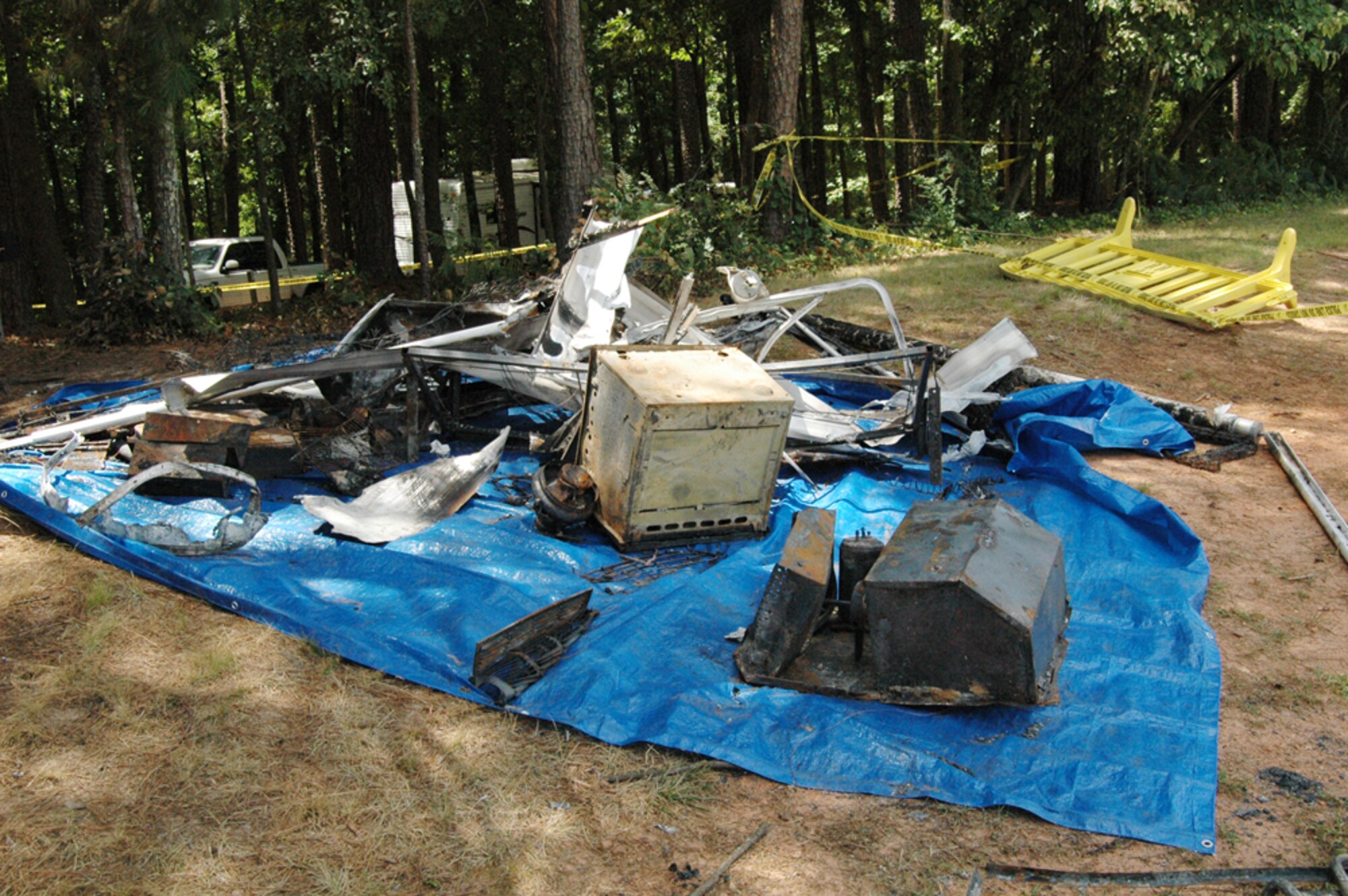 Base officials laid out items from a recreational trailer that caught on fire around 2:30 a.m. July 17. Nearly a dozen firefighters extinguished the blaze, which caused $30,000 in damages. The cause is currently under investigation. (U.S. Air Force photo/Travon Dennis)