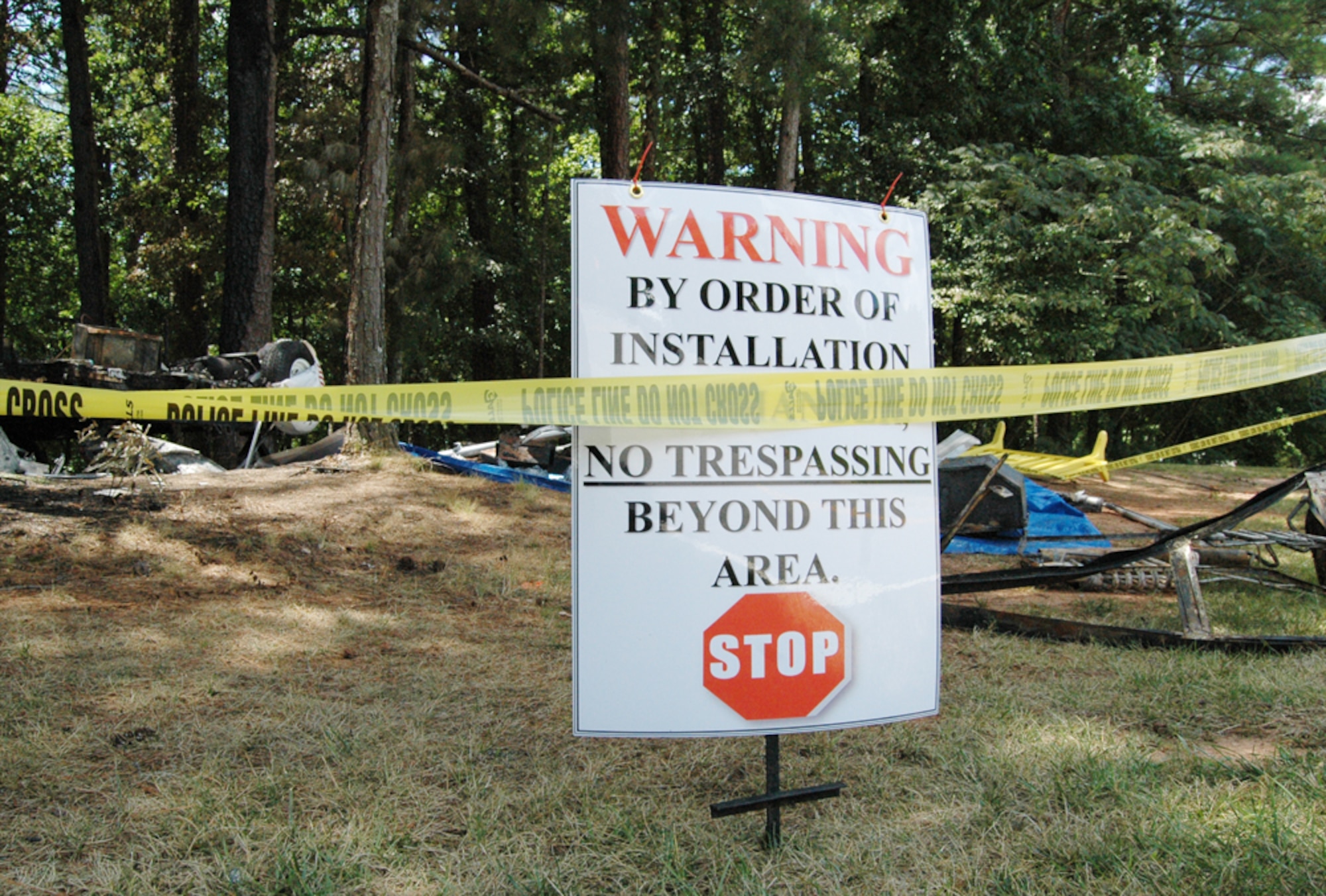 Police tape and a warning sign mark off the area where a recreational trailer caught on fire around 2:30 a.m. July 17. Nearly a dozen firefighters extinguished the blaze, which caused $30,000 in damages. The cause is currently under investigation. (U.S. Air Force photo/Travon Dennis)
