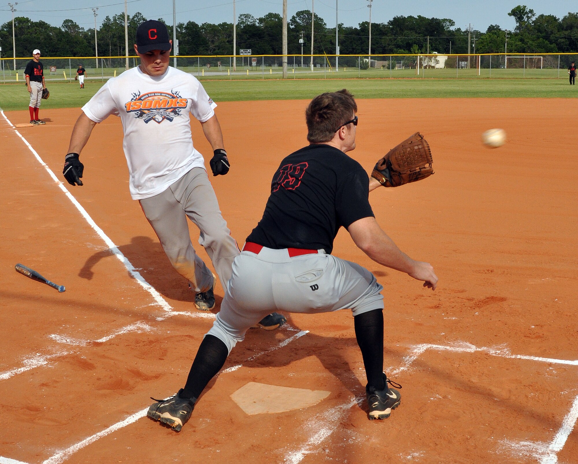 EGLIN AIR FORCE BASE, Fla. –  A player from the 1st Special Operations Maintenance Squadron races to tag home as the throw comes into the plate during the 2009 Intramural Softball Championship game against the Fire Department, July 16. The Fire Department defeated the 1st SOMXS, the defending champs, in a double header. (U.S. Air Force photo/ Airman Anthony Jennings)