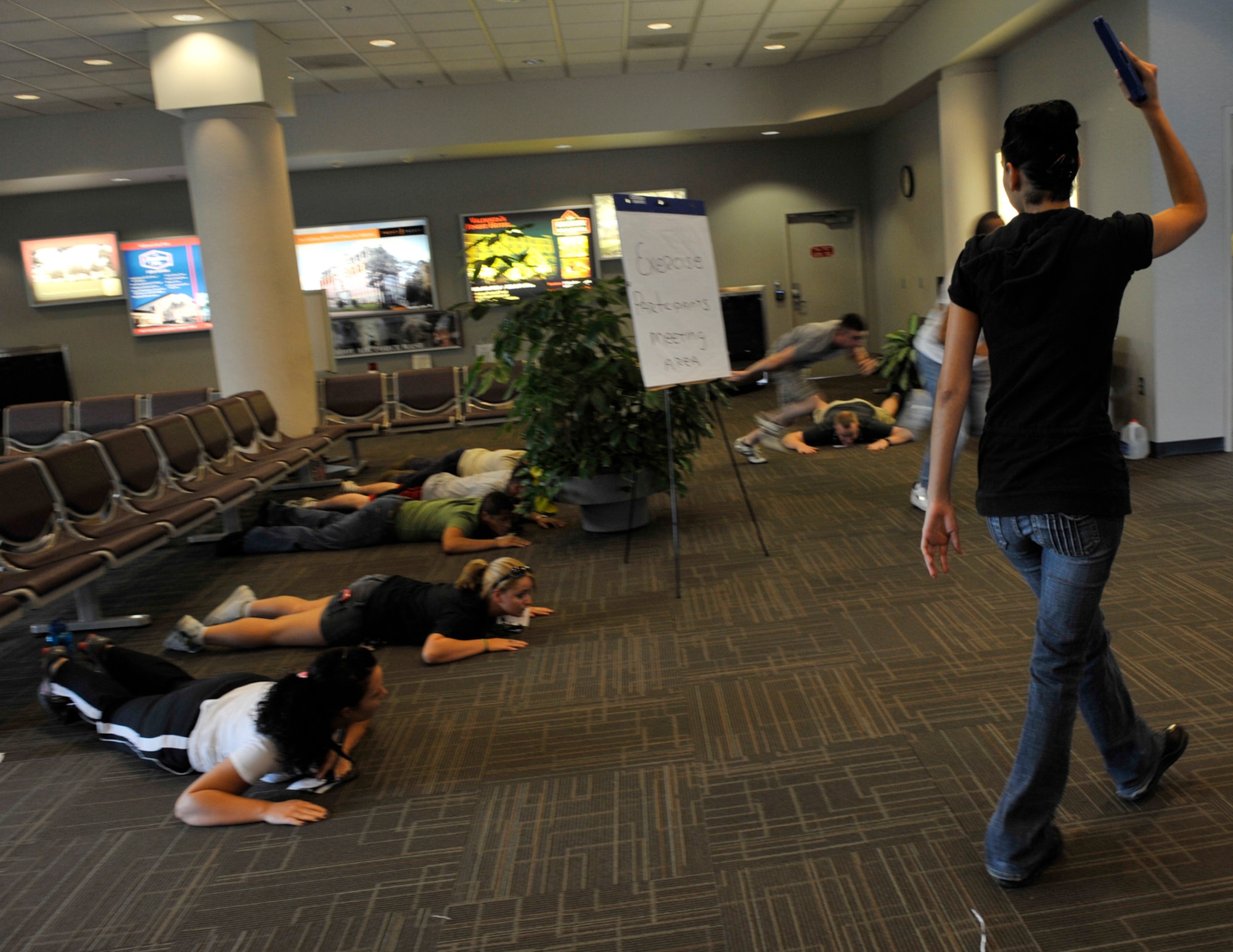 MOODY AIR FORCE BASE, Ga. -- Staff Sgt. Crystal Garcia, 23rd Security Forces Squadron investigations, orders hostages to get on the ground at the Valdosta Regional Airport July 18. Sergeant Garcia, Moody Airmen and local community members participated in an emergency response exercise at the airport. (U.S. Air Force photo by Senior Airman Schelli Jones)
